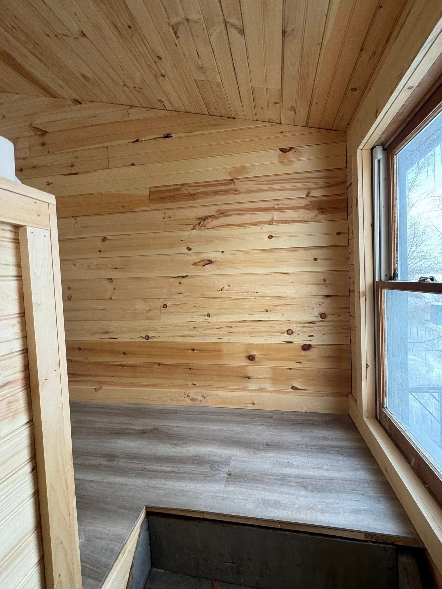 A window is being built into a wall in a room.