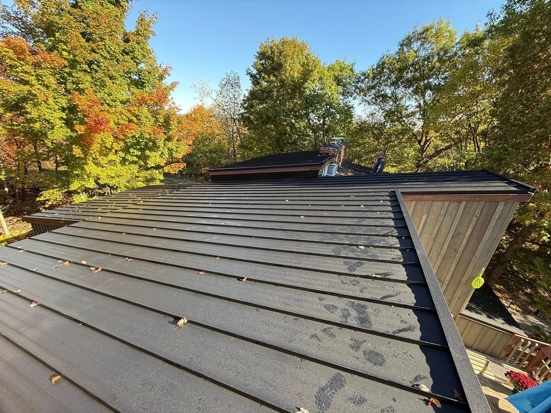 A group of people are working on a wooden roof.