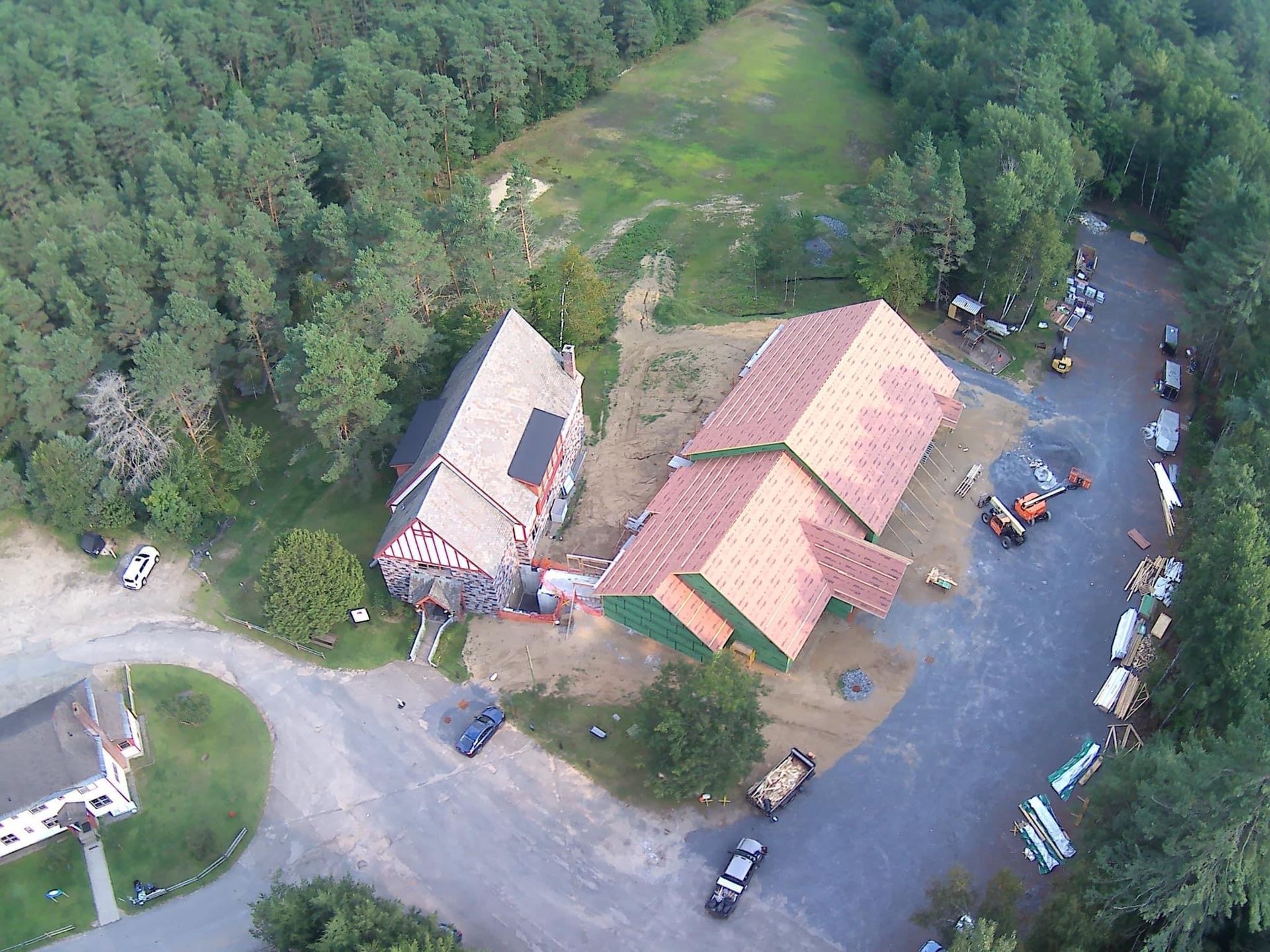 An aerial view of a house in the middle of a forest