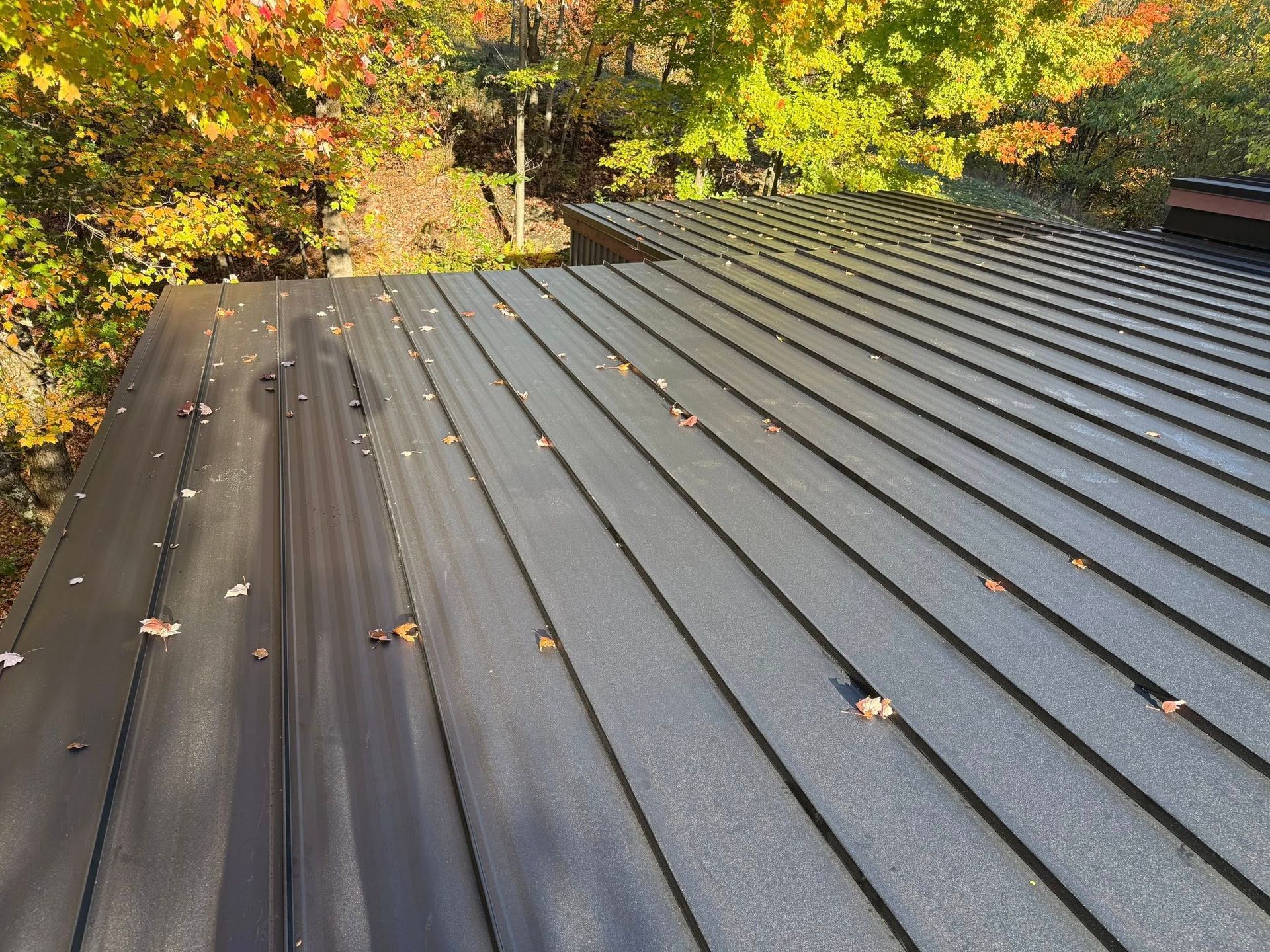 A group of people are working on a wooden roof.