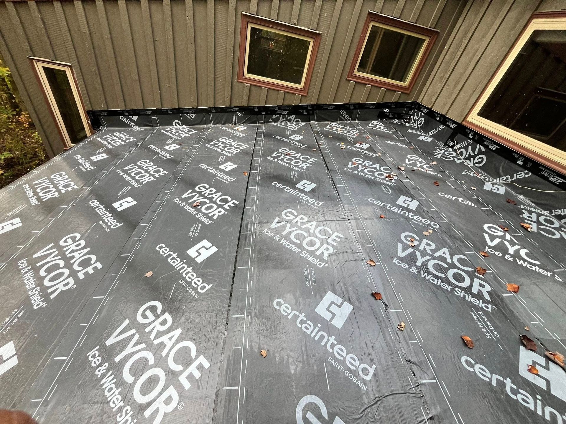 A white house with a scaffolding on the side of it.