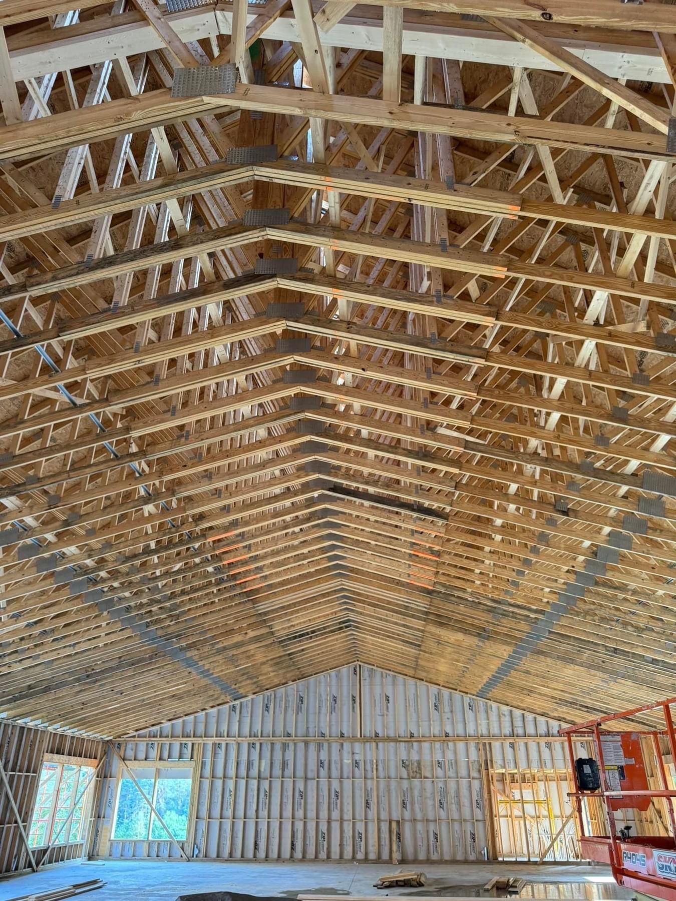 The inside of a building under construction with a lot of wooden beams.