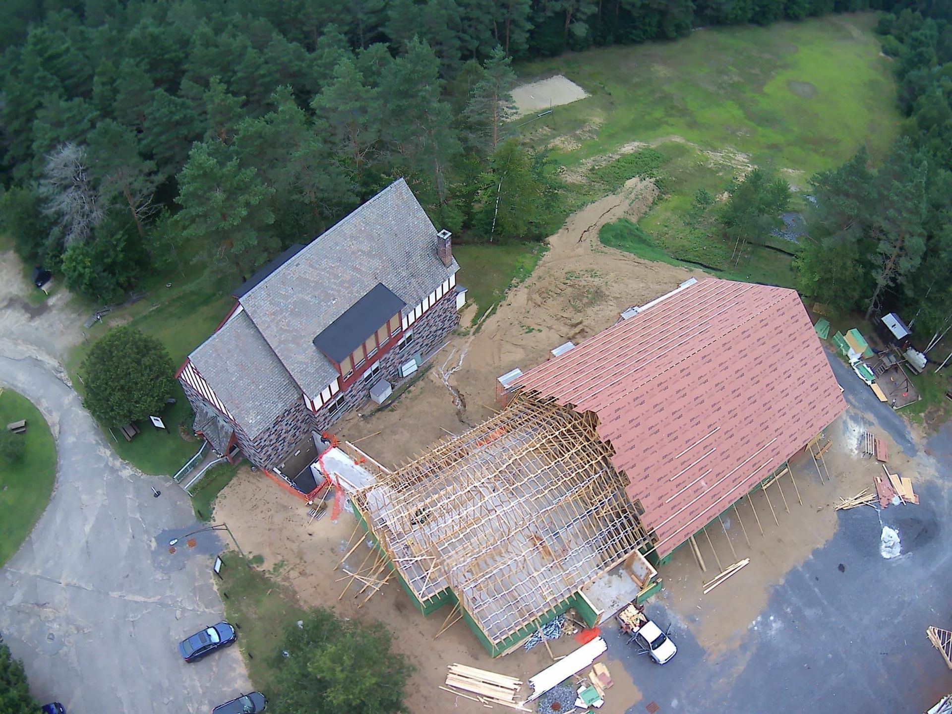 An aerial view of a house under construction with a red roof