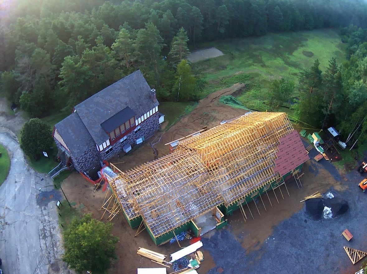 An aerial view of a house under construction in a field