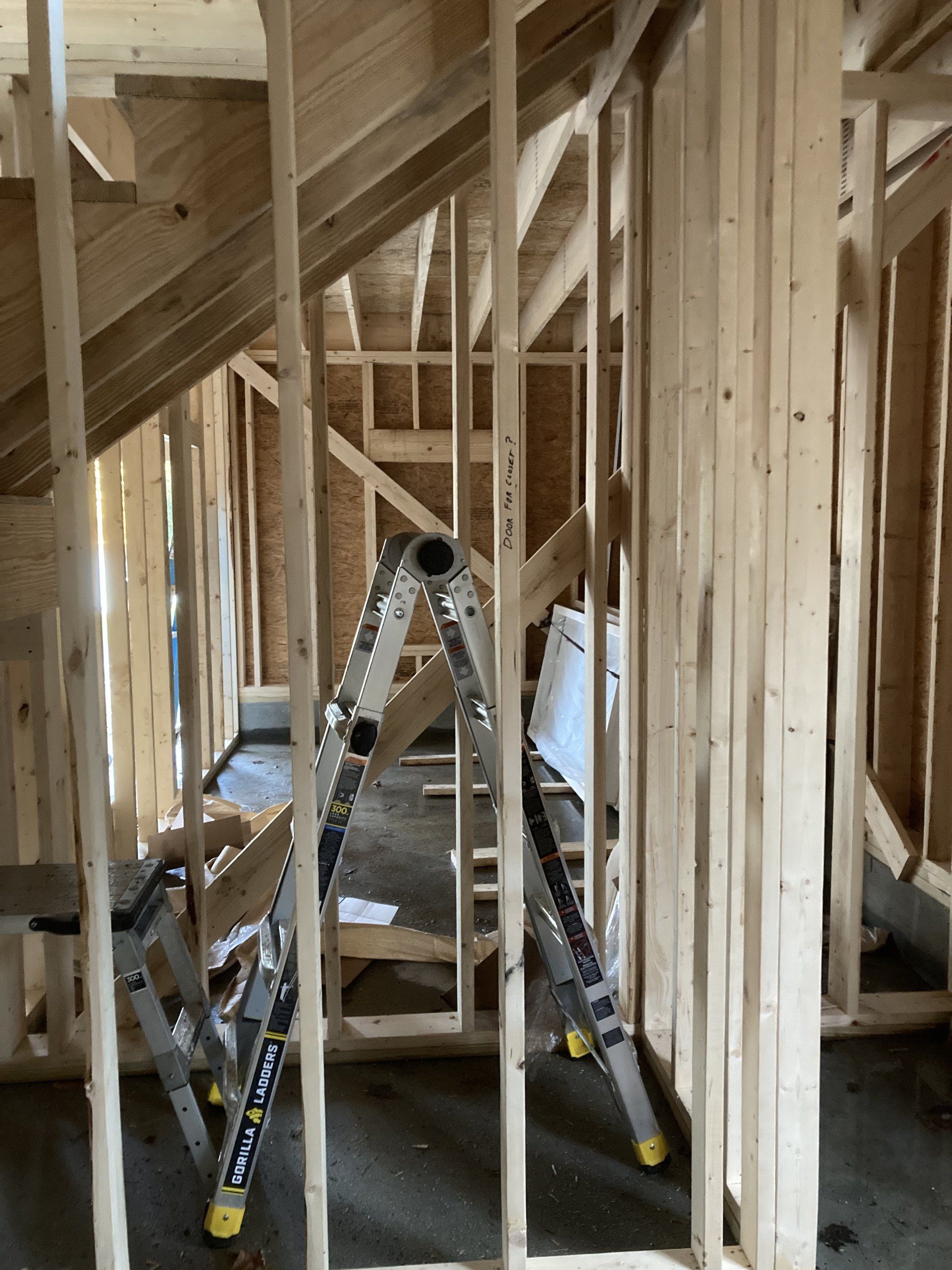 A ladder is sitting in the middle of a wooden structure.