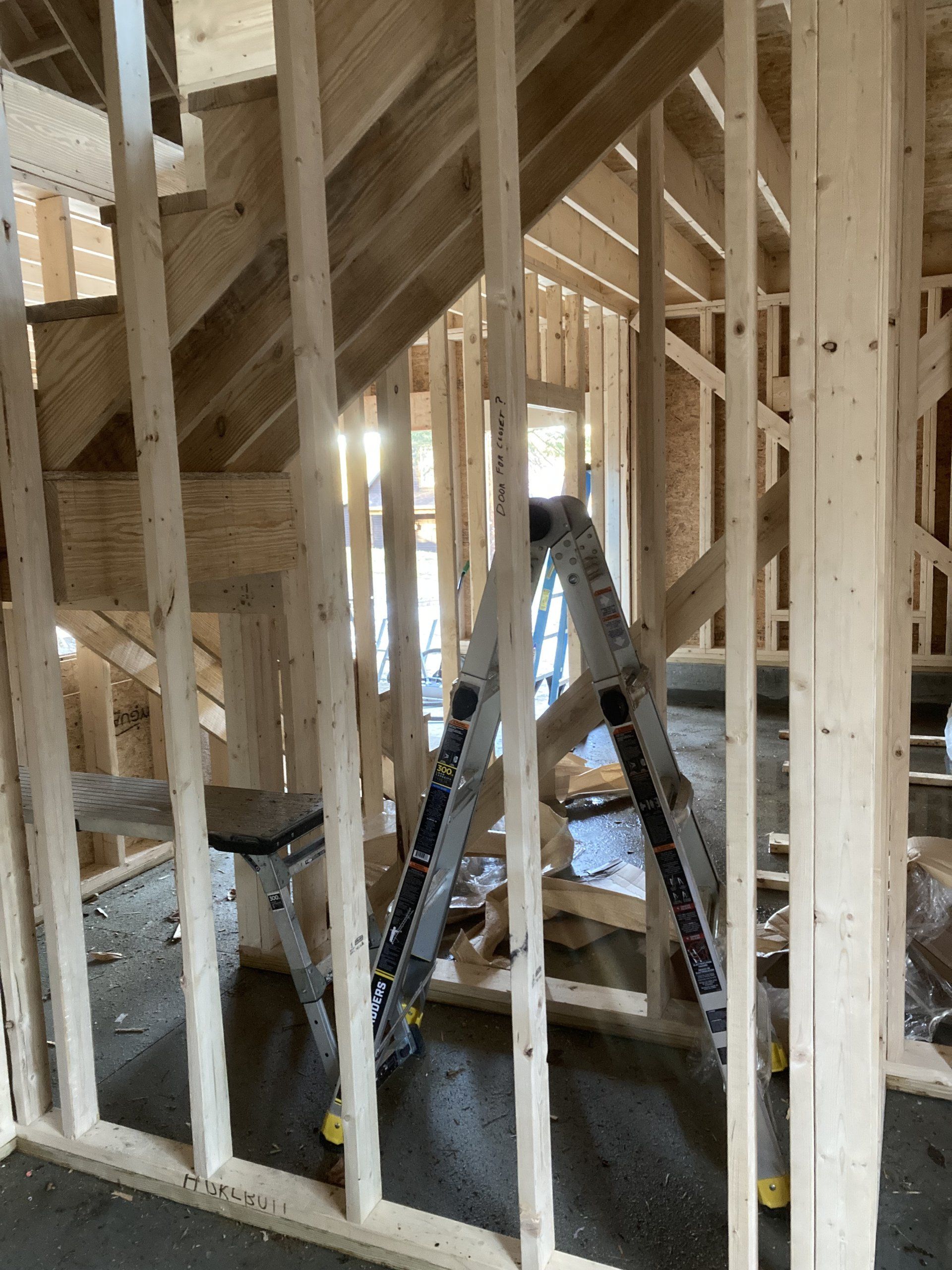 A ladder is sitting in the middle of a building under construction.