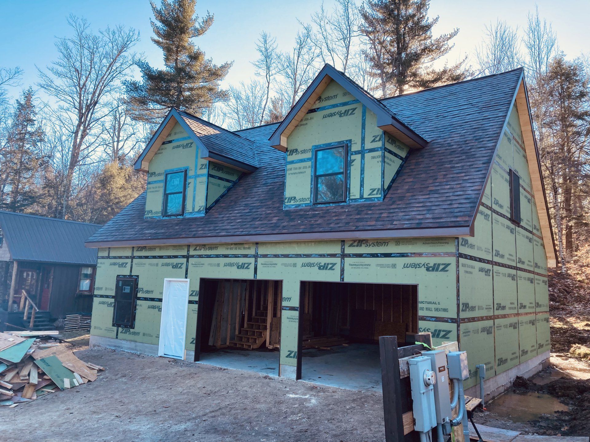 A house that is being built with a garage underneath it.