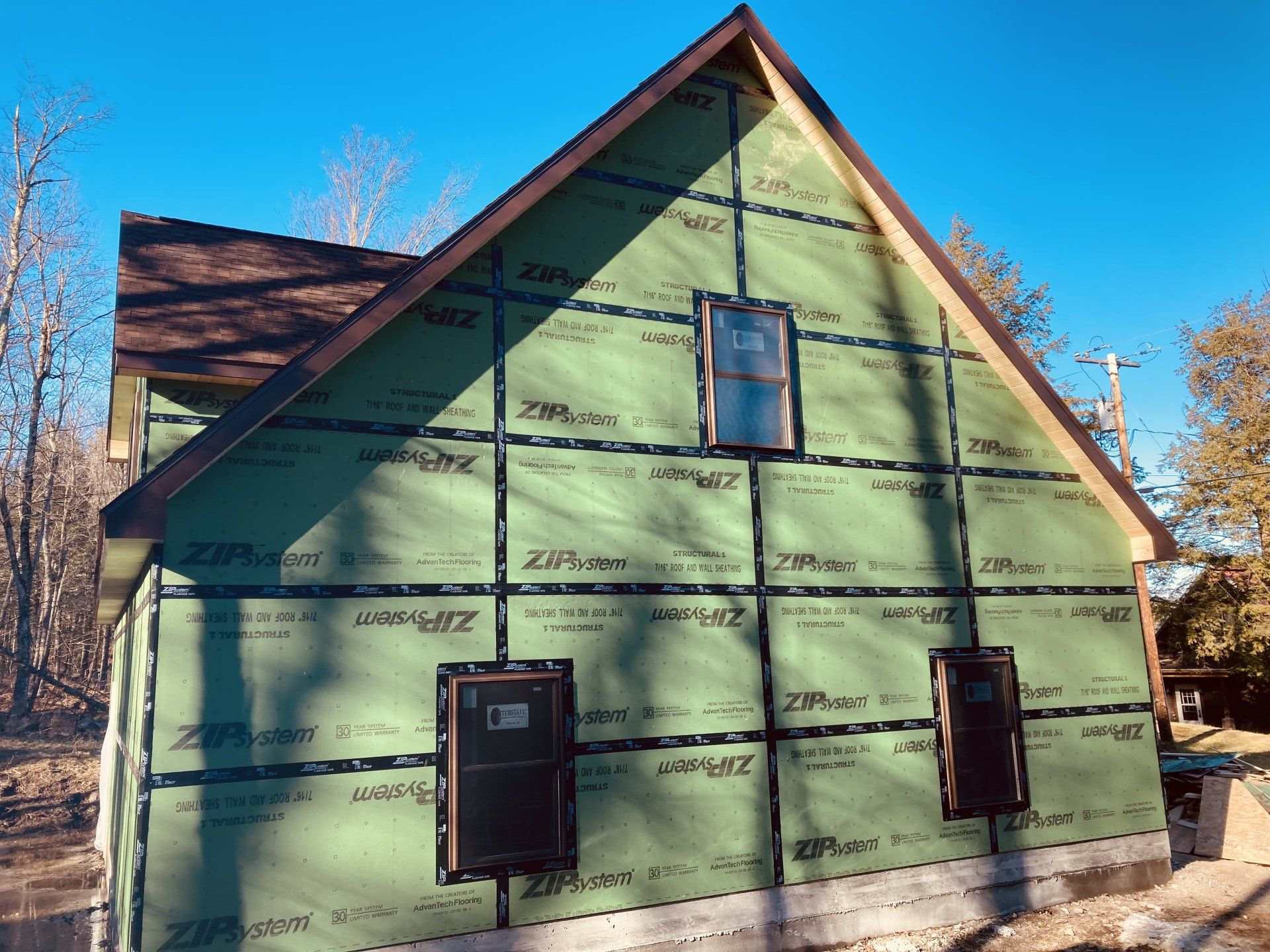 A house that is being built with green siding