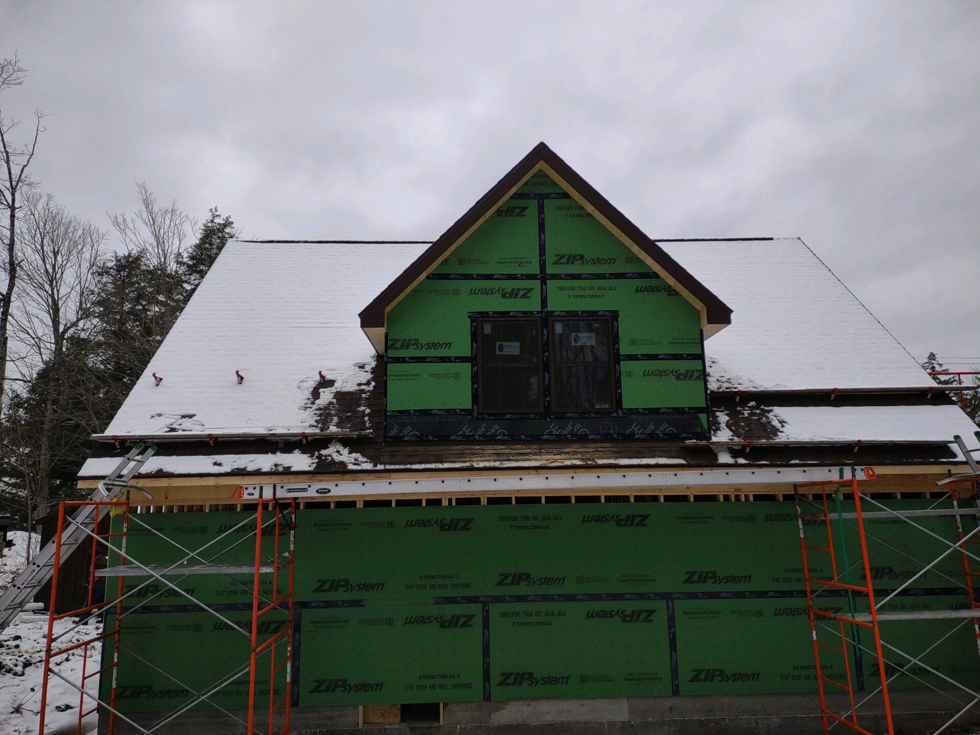 A house that is being built with scaffolding around it
