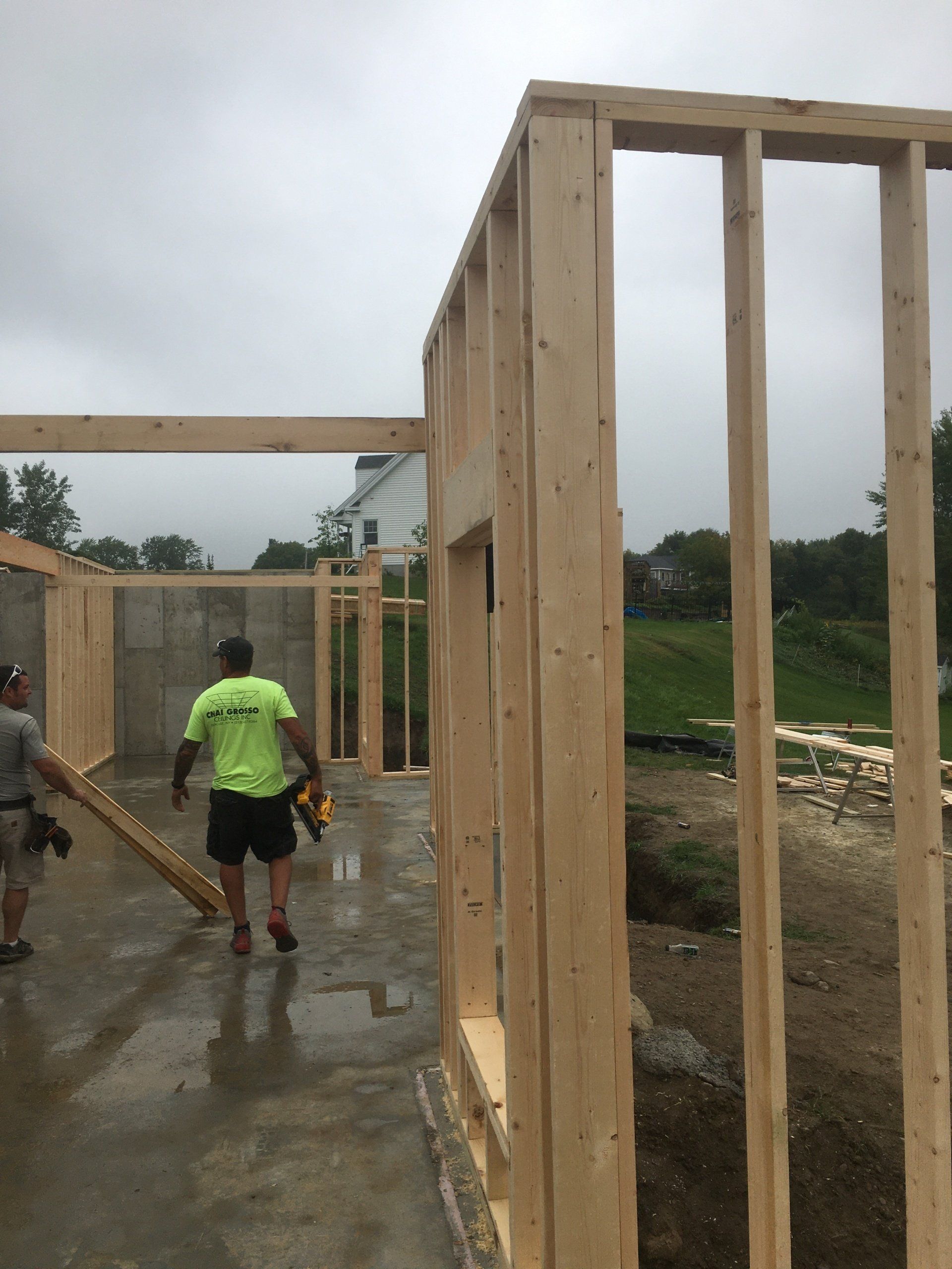 A man wearing a neon green shirt that says ' a & a ' on it