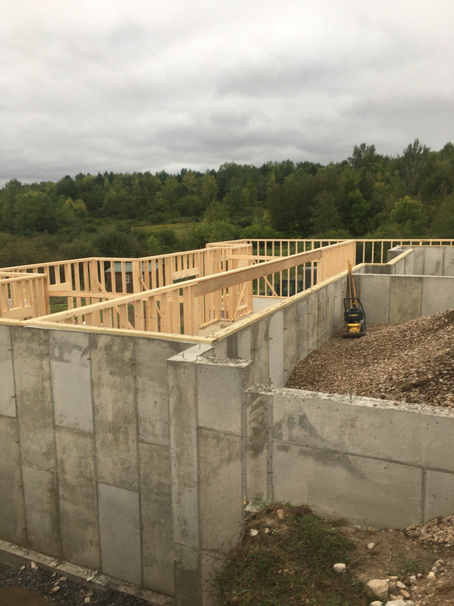The foundation of a house is being built with wooden beams.