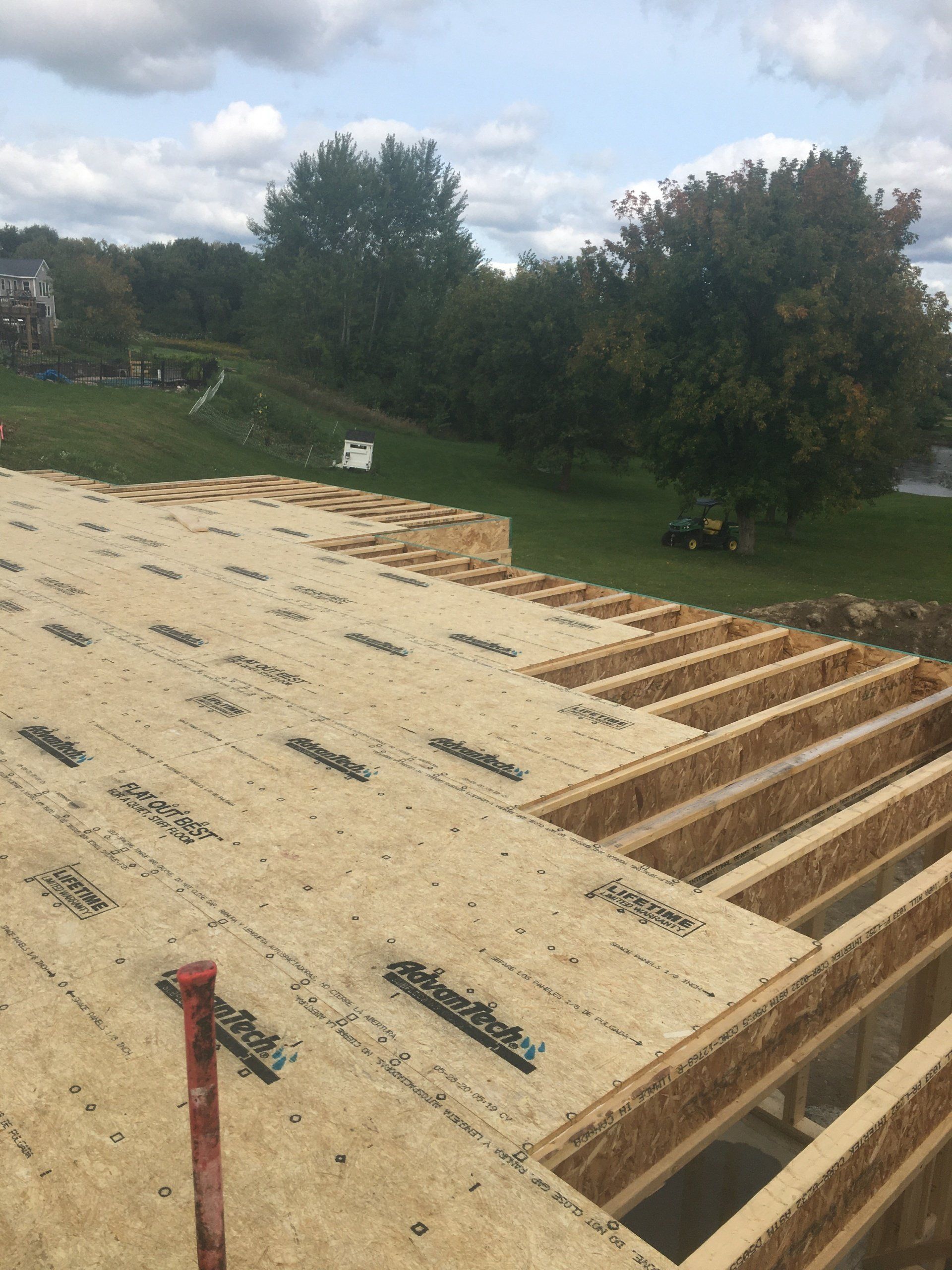 The roof of a house is being built and is covered in plywood.