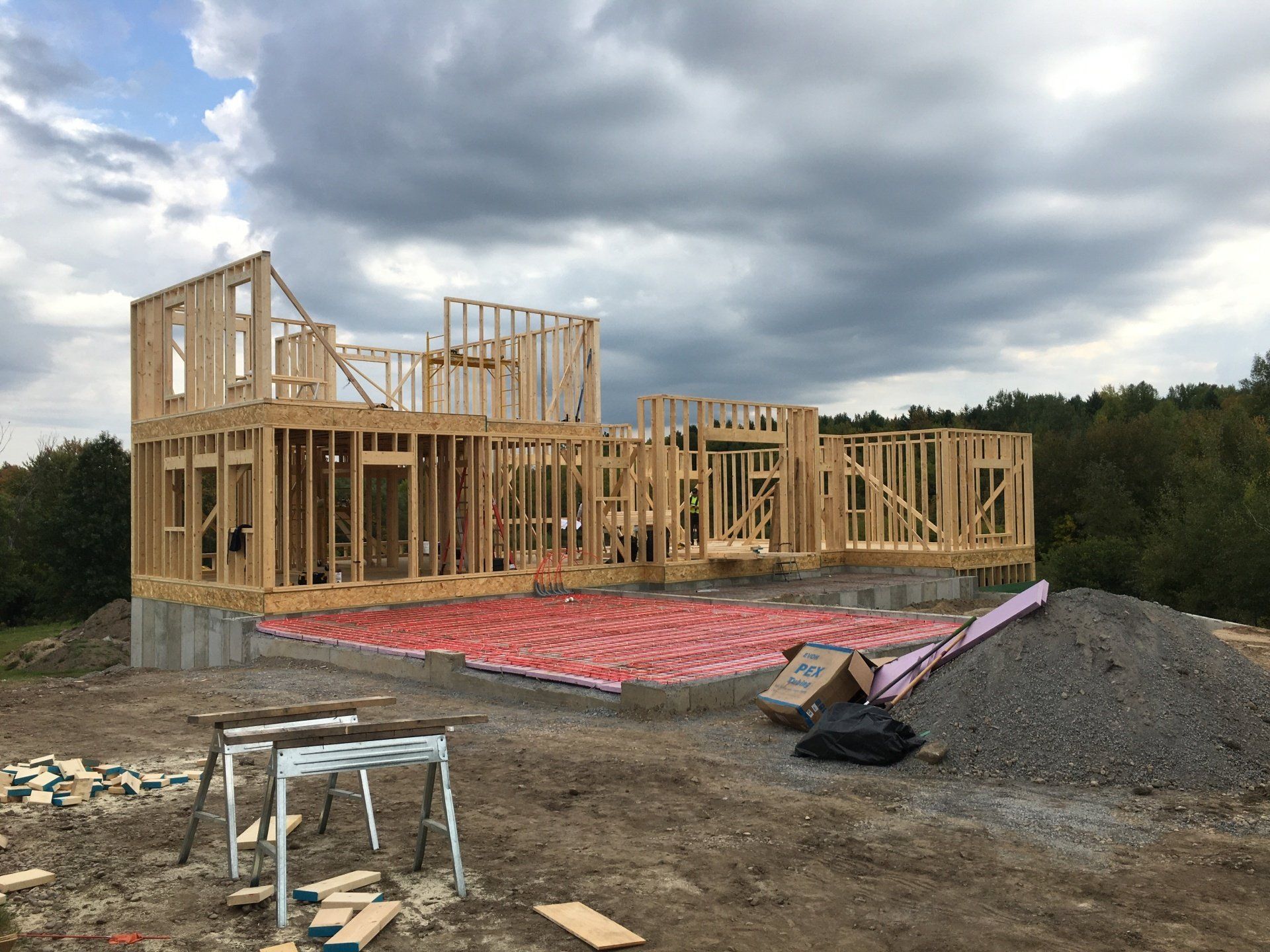 A house is being built in the middle of a dirt field.