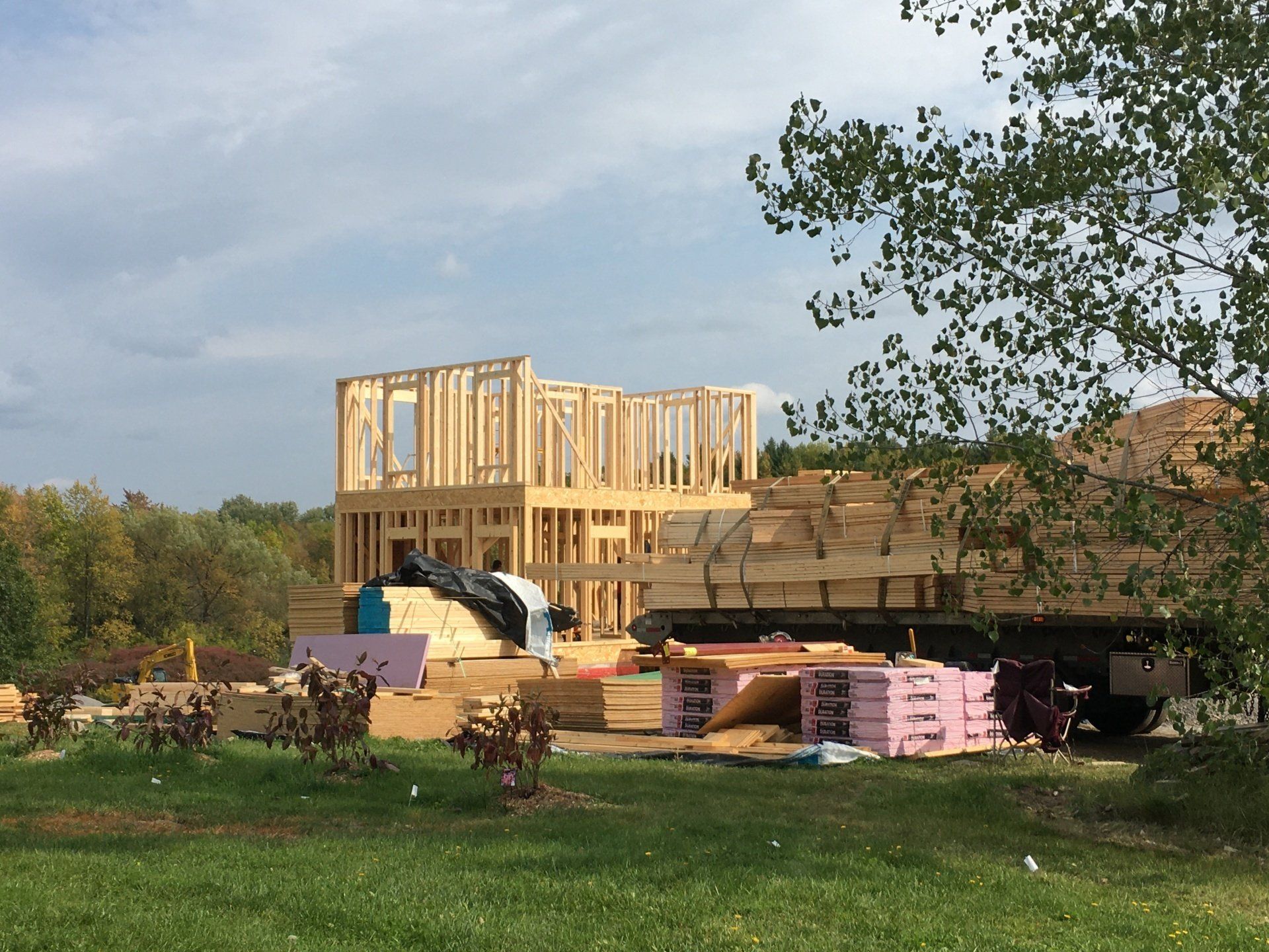 A house is being built in the middle of a grassy field