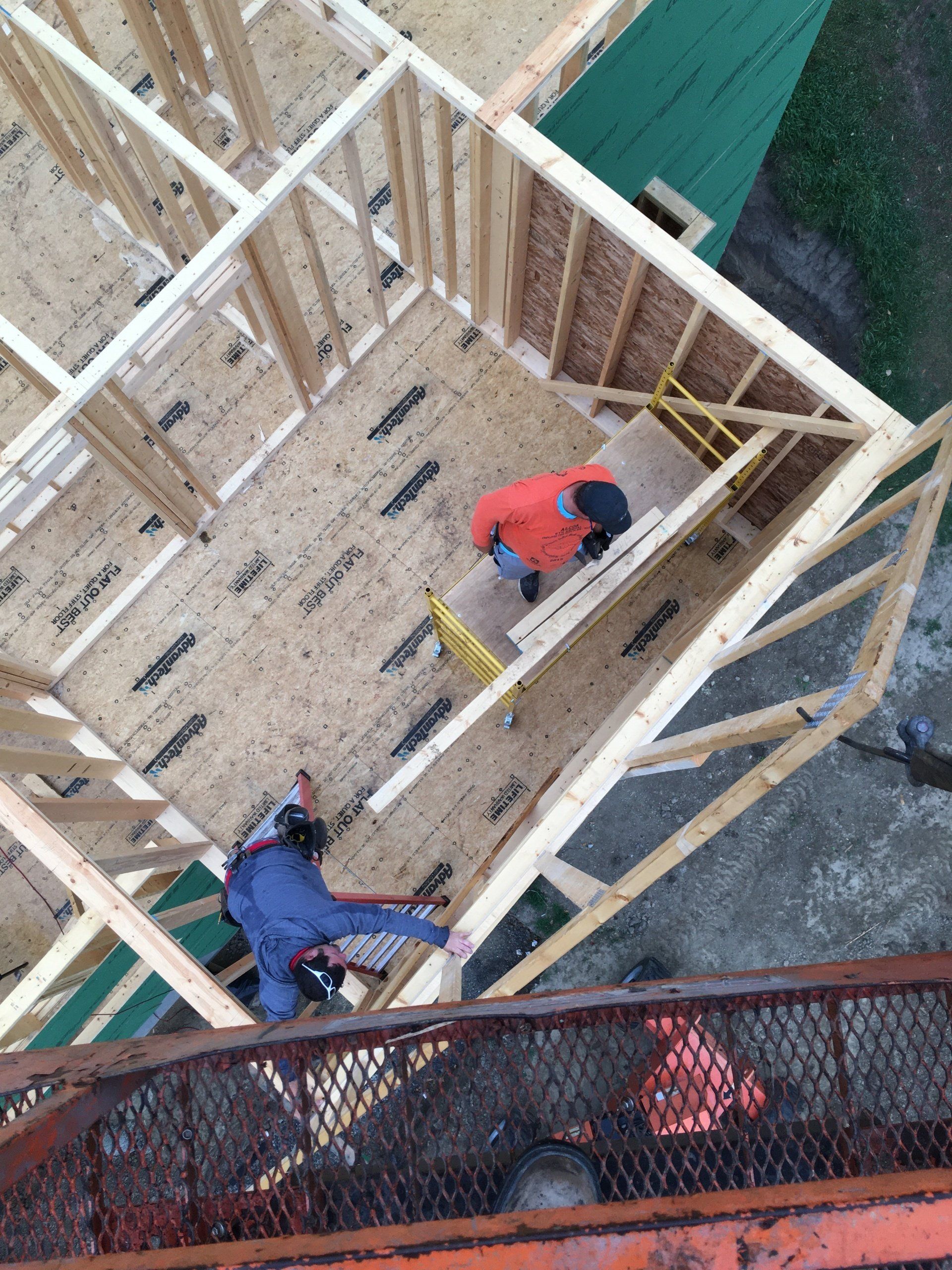 A group of construction workers are working on a building under construction.