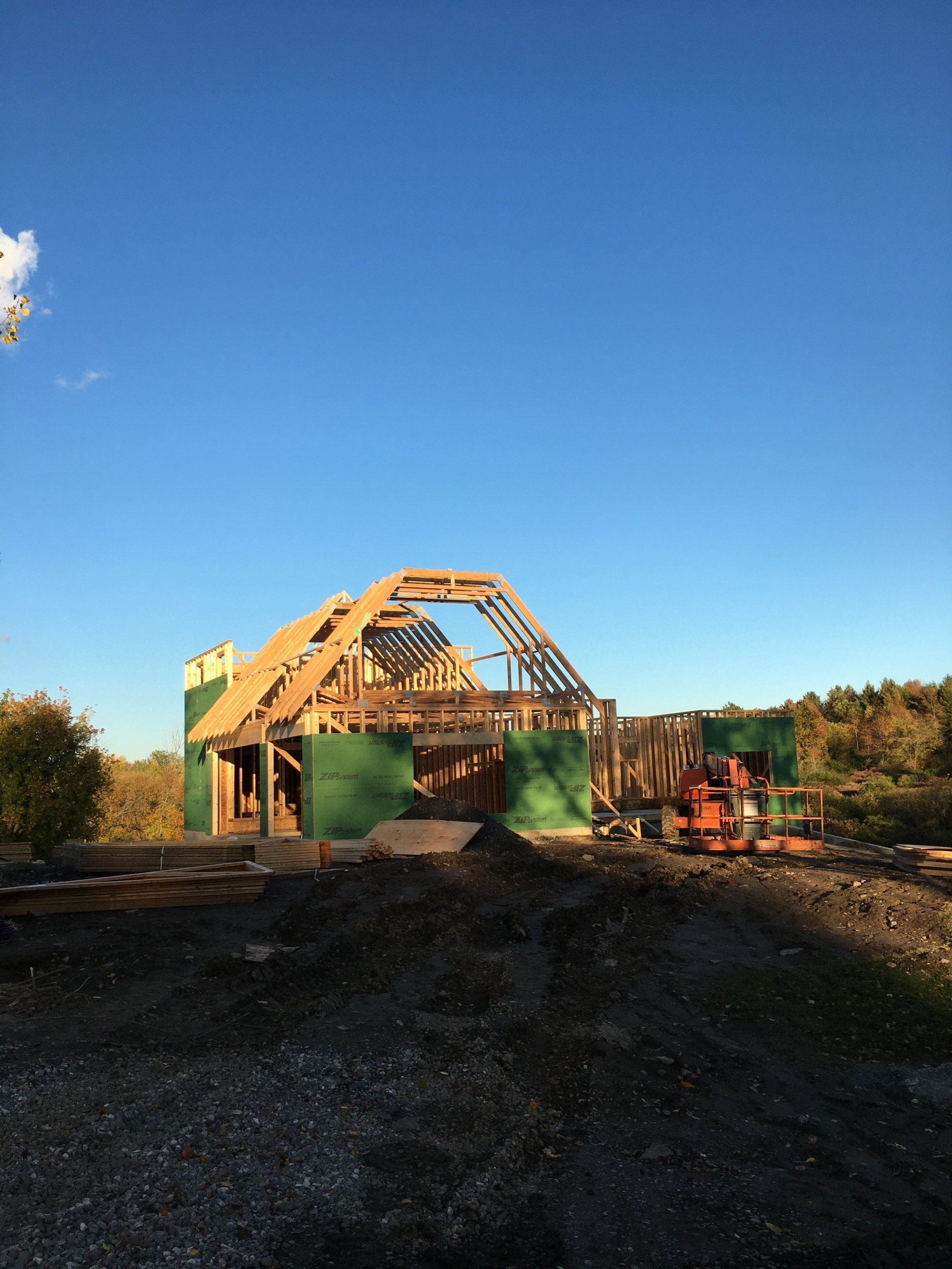 A house is being built in the middle of a dirt field.