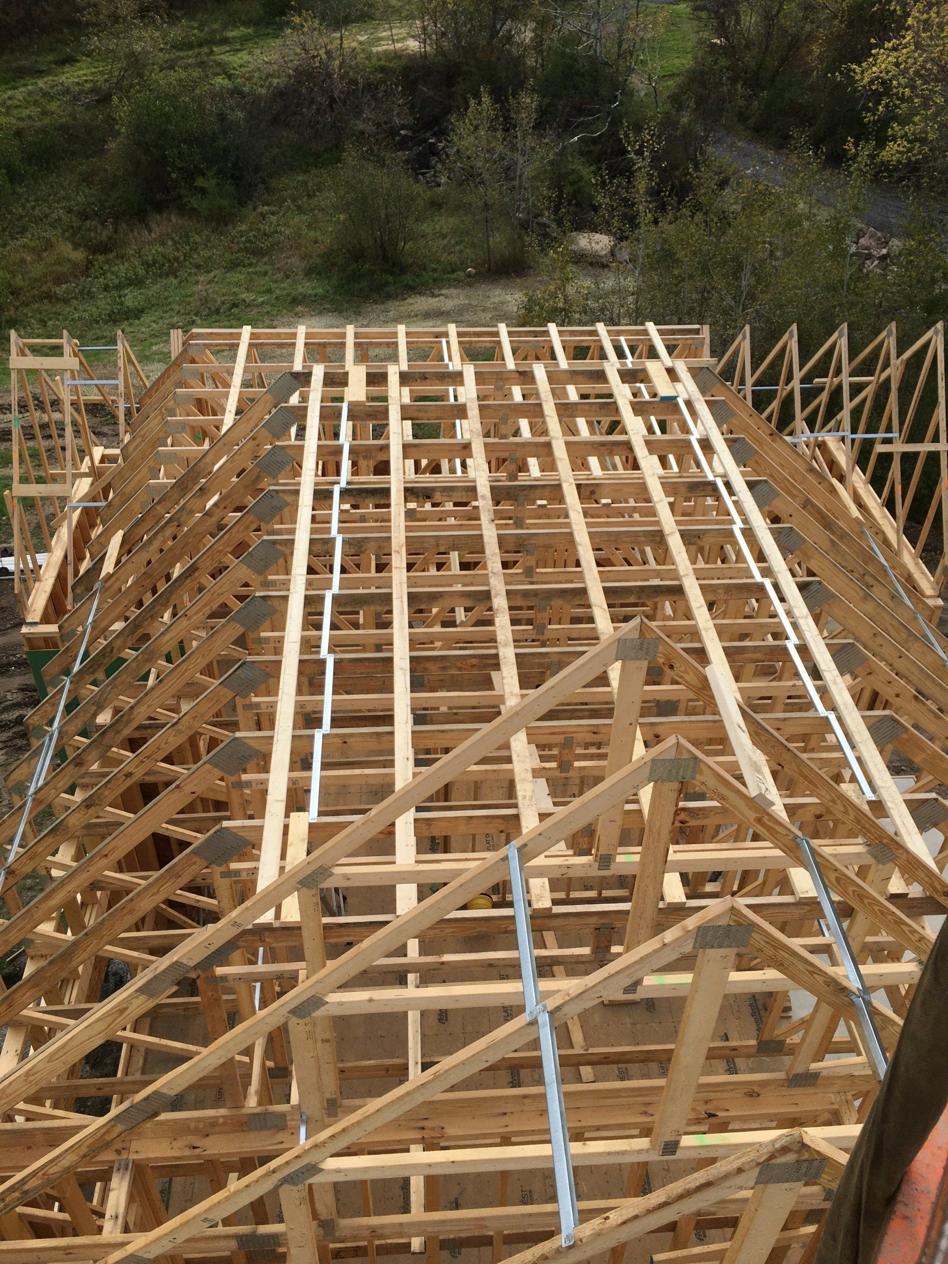 The roof of a building is being built with wooden beams.
