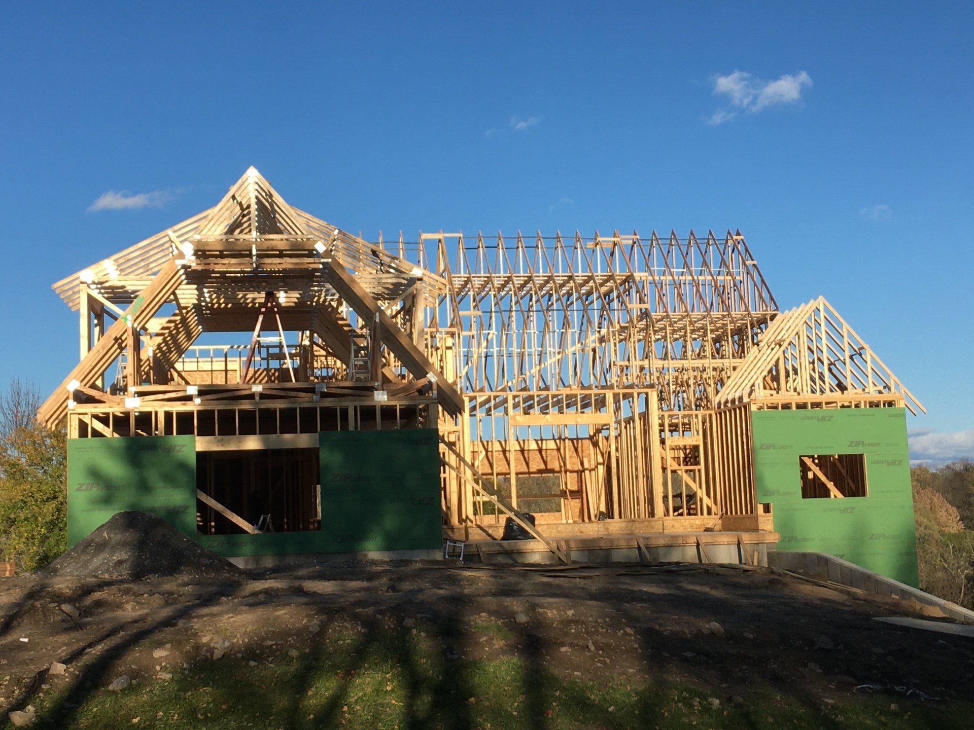 A house that is being built with a blue sky in the background