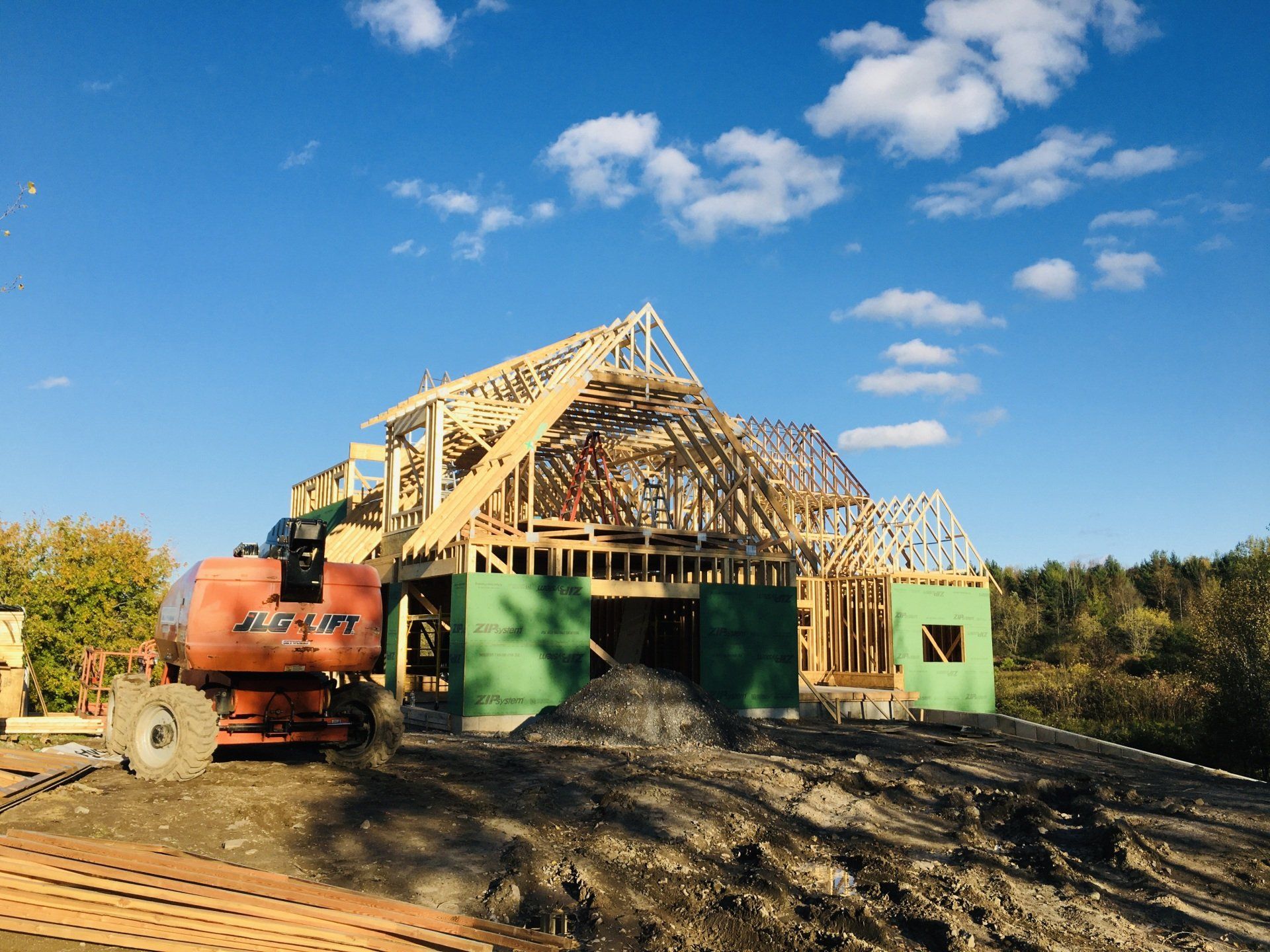 A house is being built in the middle of a dirt field.
