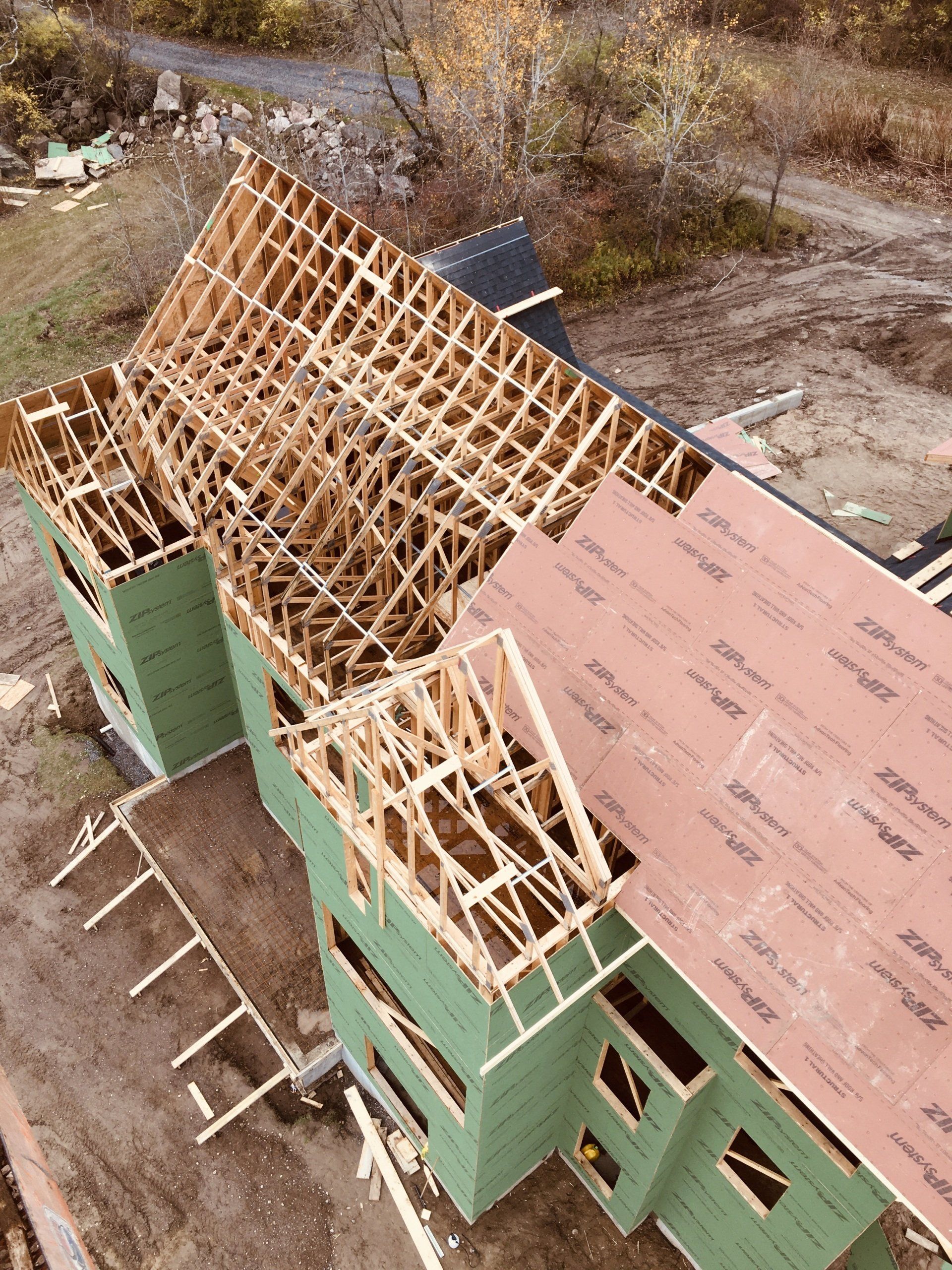 An aerial view of a house under construction with a wooden roof