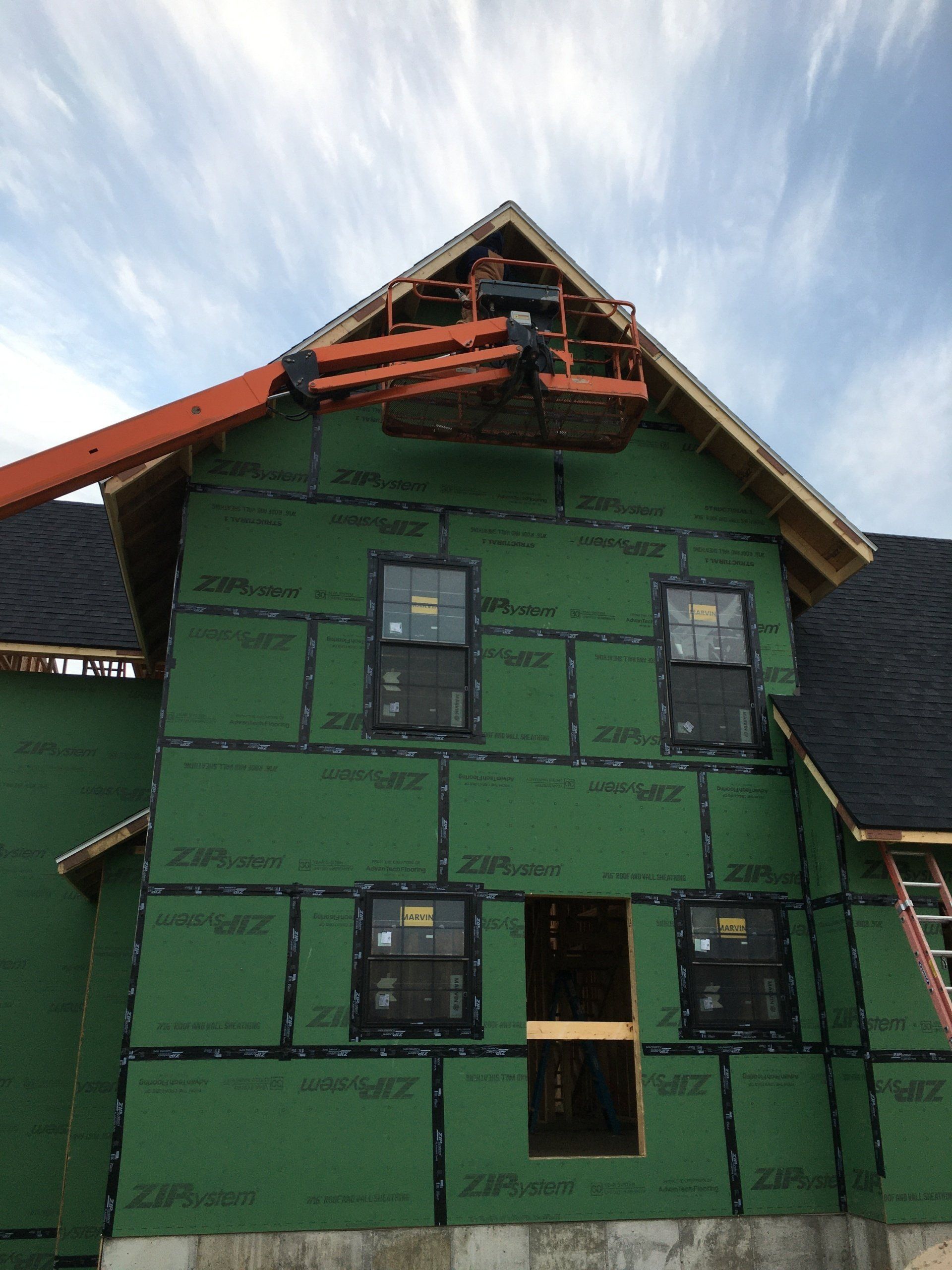 A building under construction with a crane on top of it
