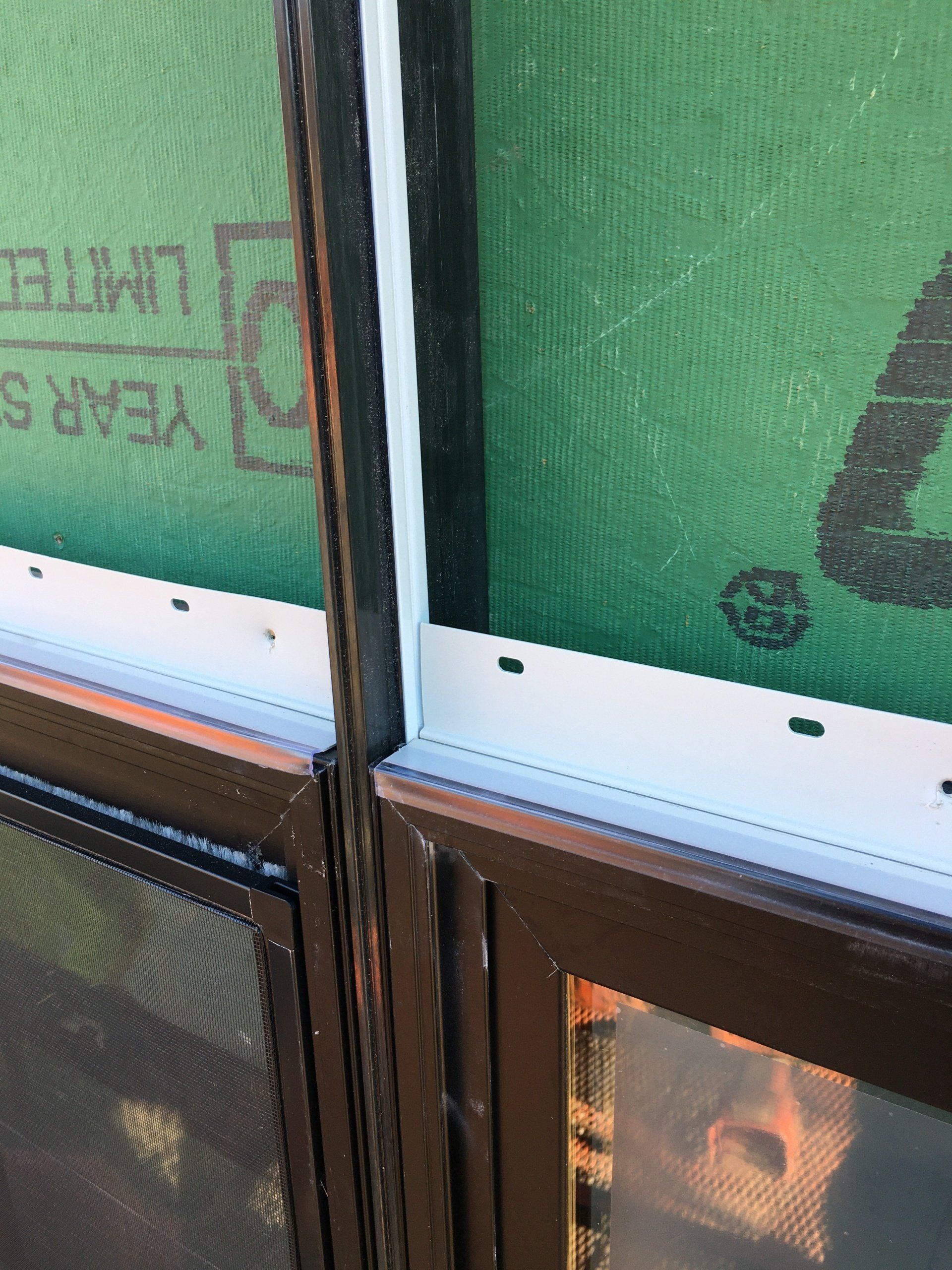 A close up of a window with a screen on it.