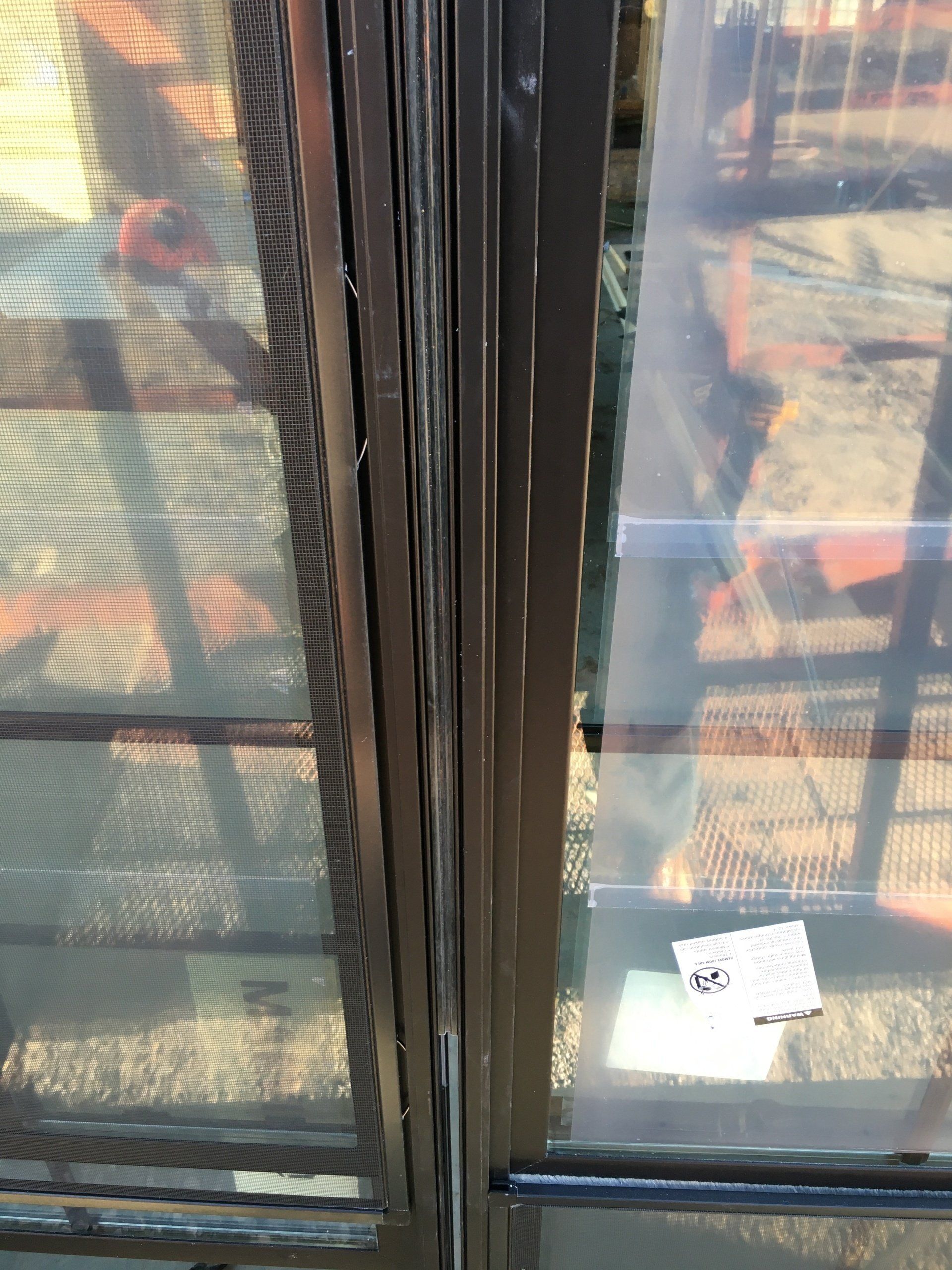 A close up of a window with a reflection of stairs