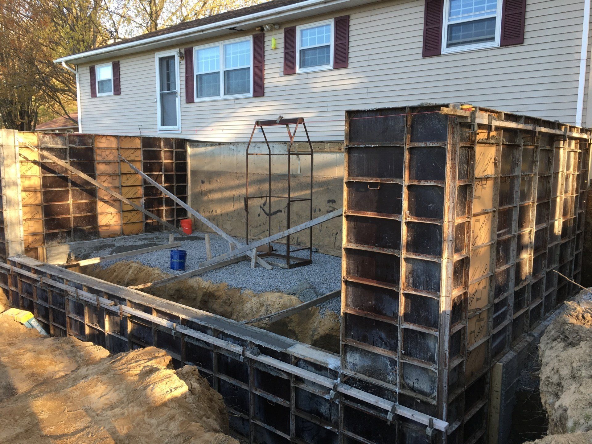 A house is being remodeled with a foundation being built.