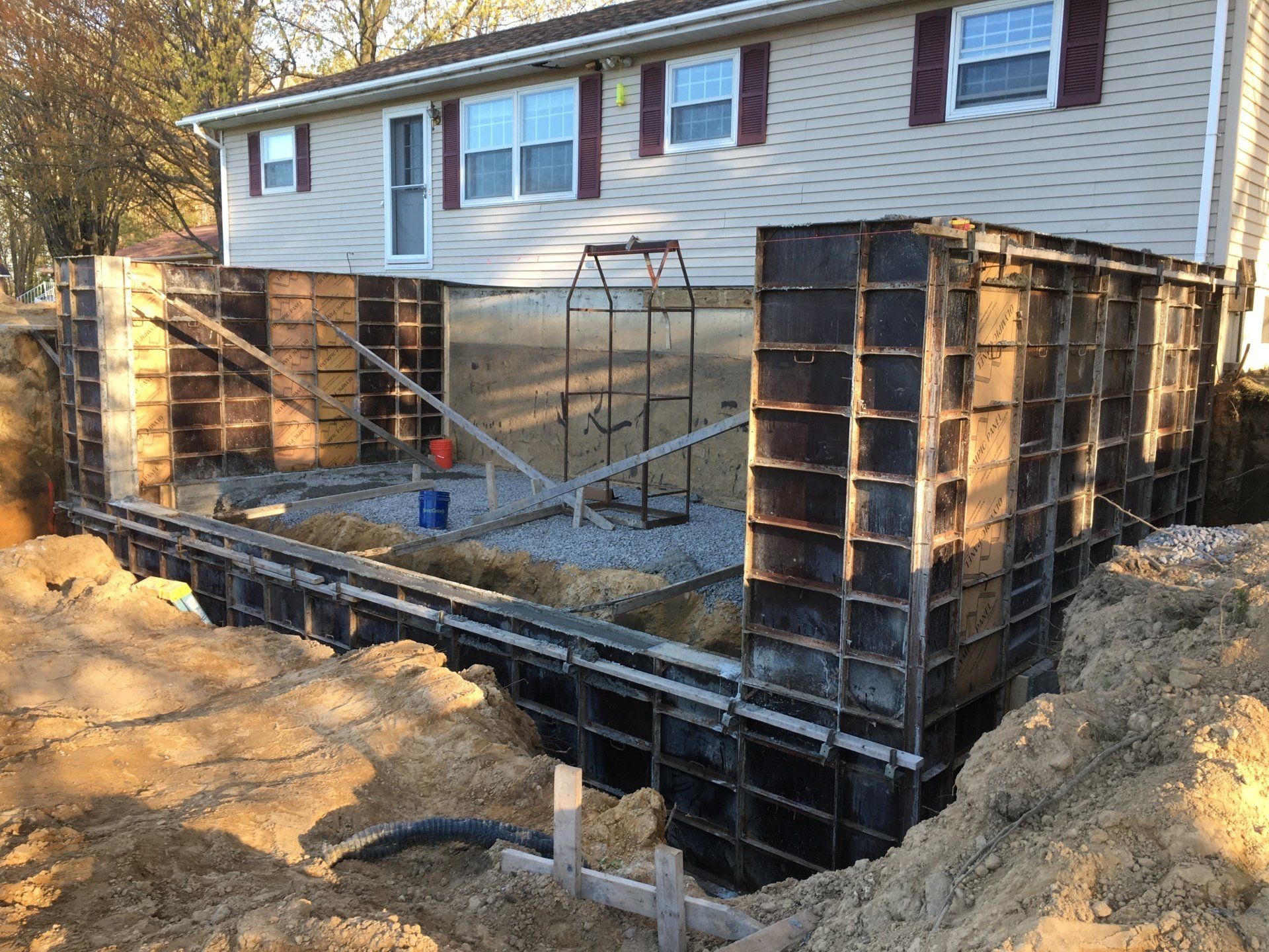 A house is being built on top of a dirt hill.