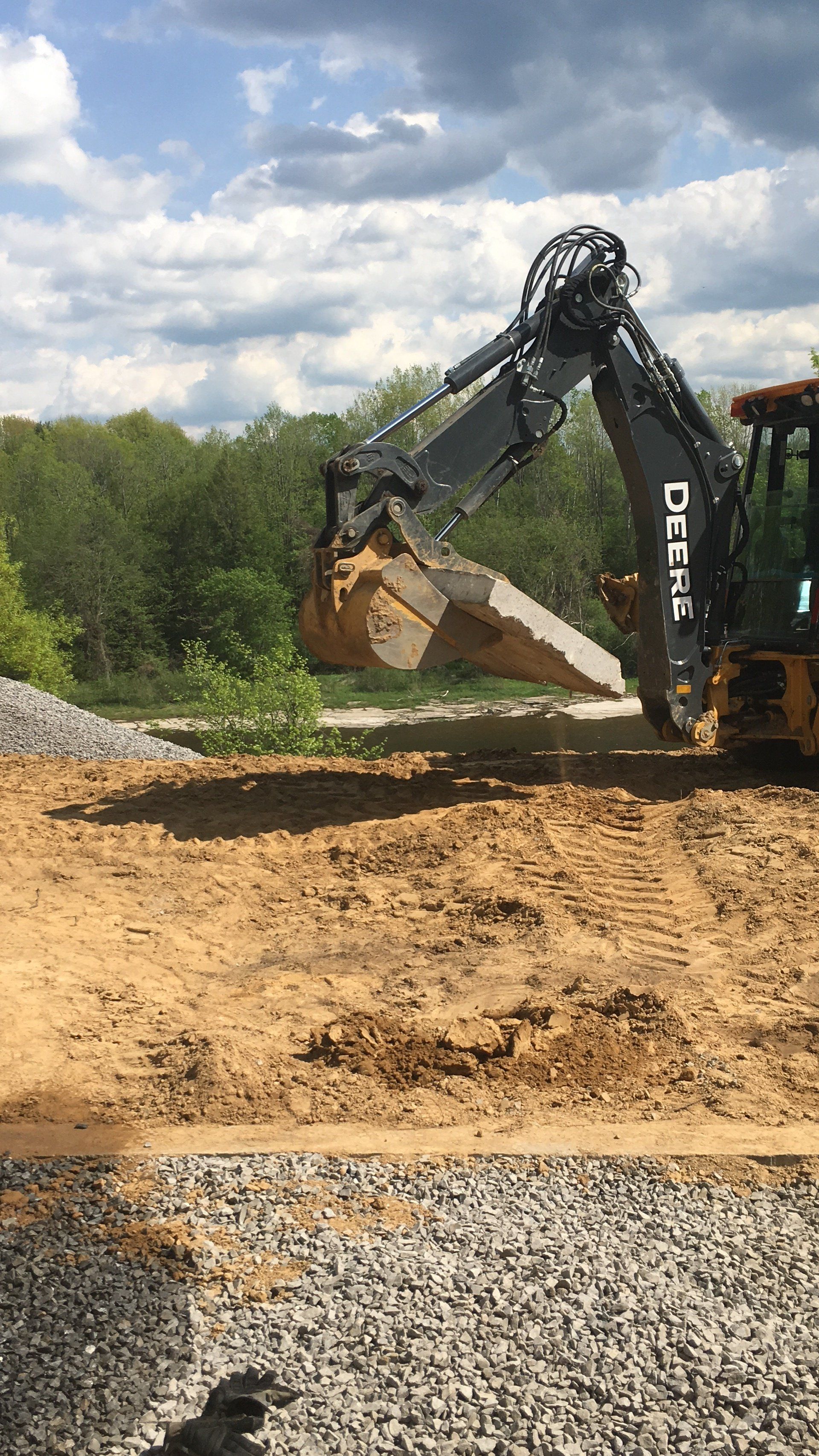 A large excavator is digging a hole in the dirt.