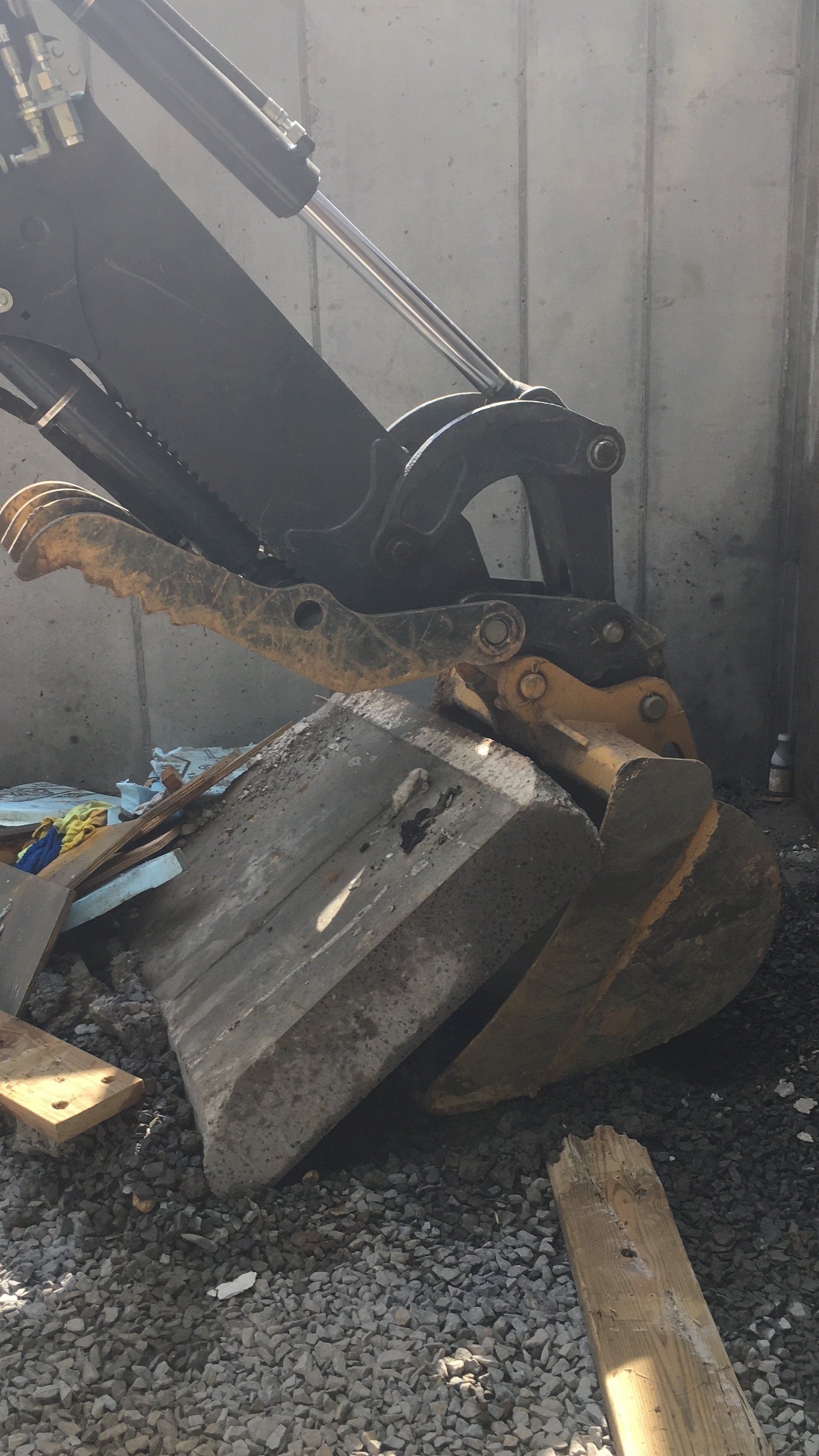 A bulldozer is sitting on top of a pile of gravel.