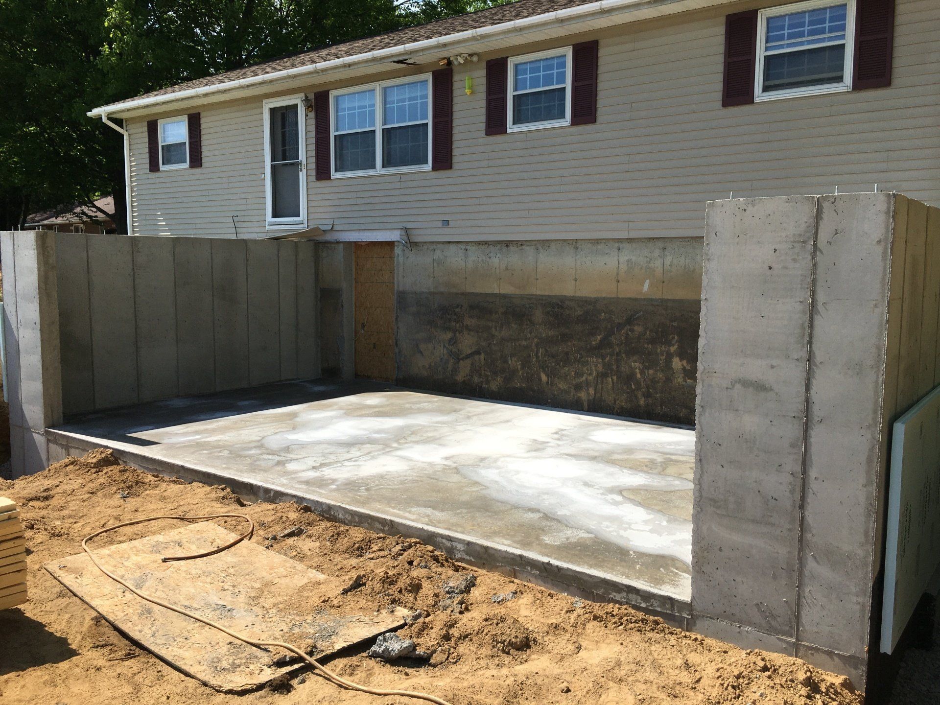 A house with a concrete driveway in front of it