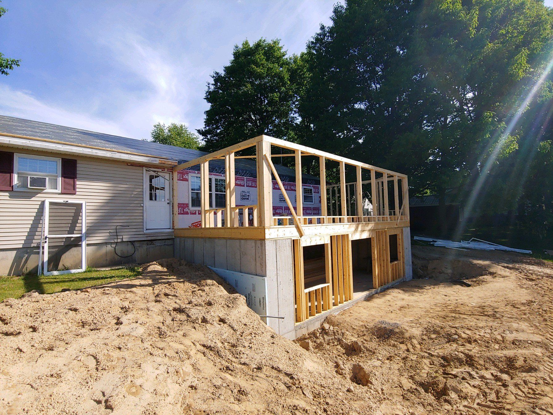 A house is being remodeled with a deck being built on top of it.