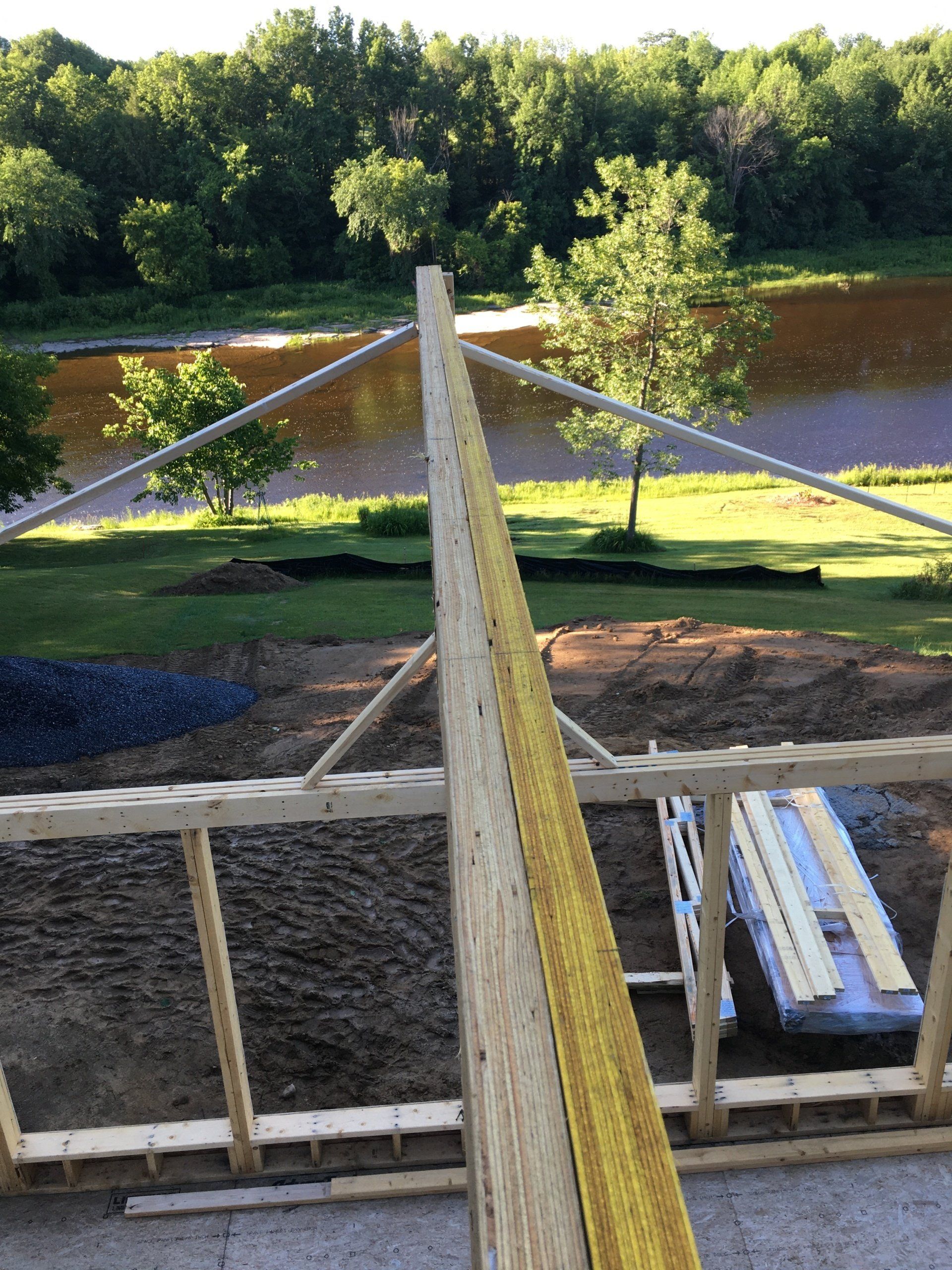 A construction site with a view of a river and trees