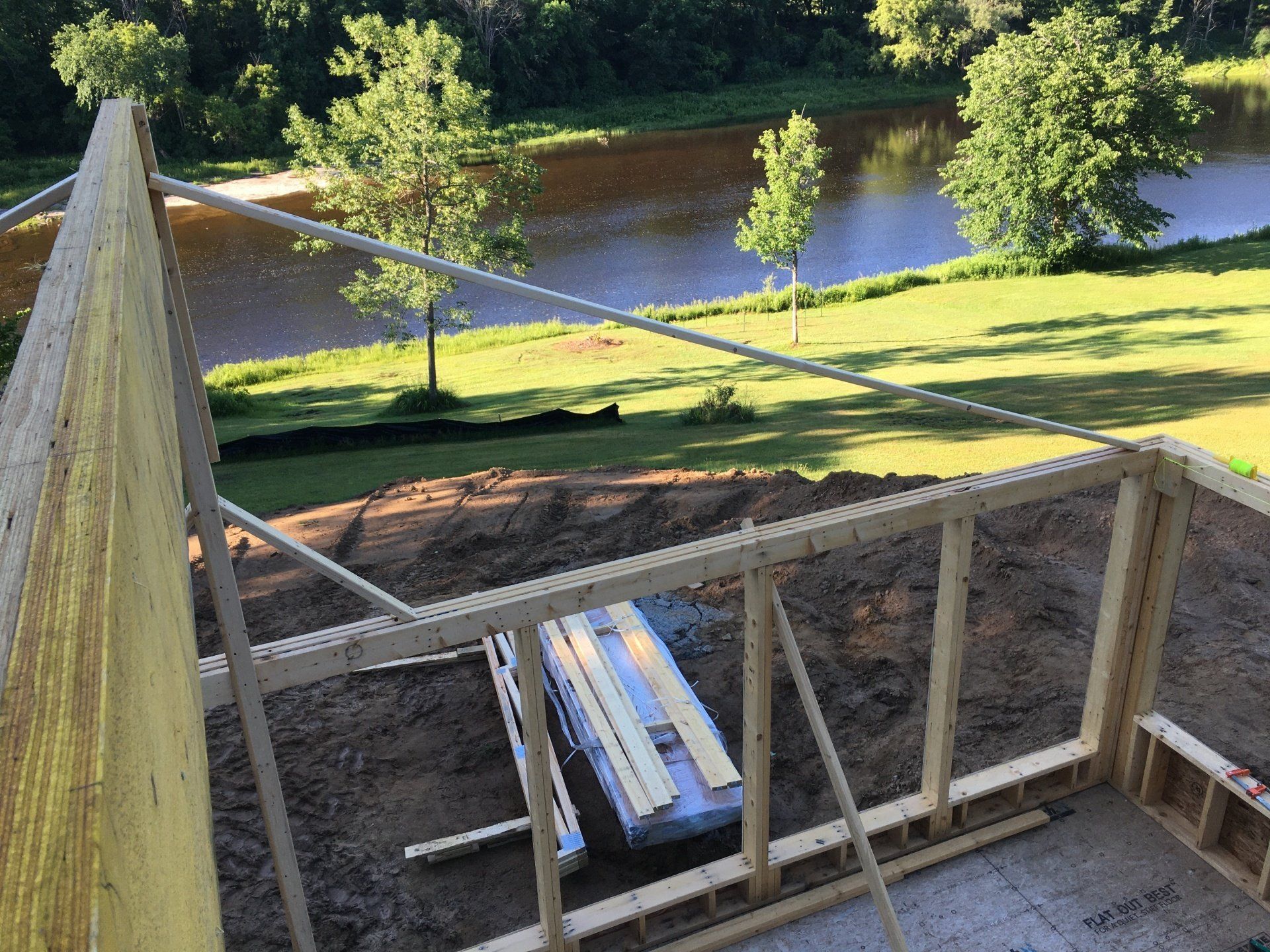 A building under construction with a view of a river.