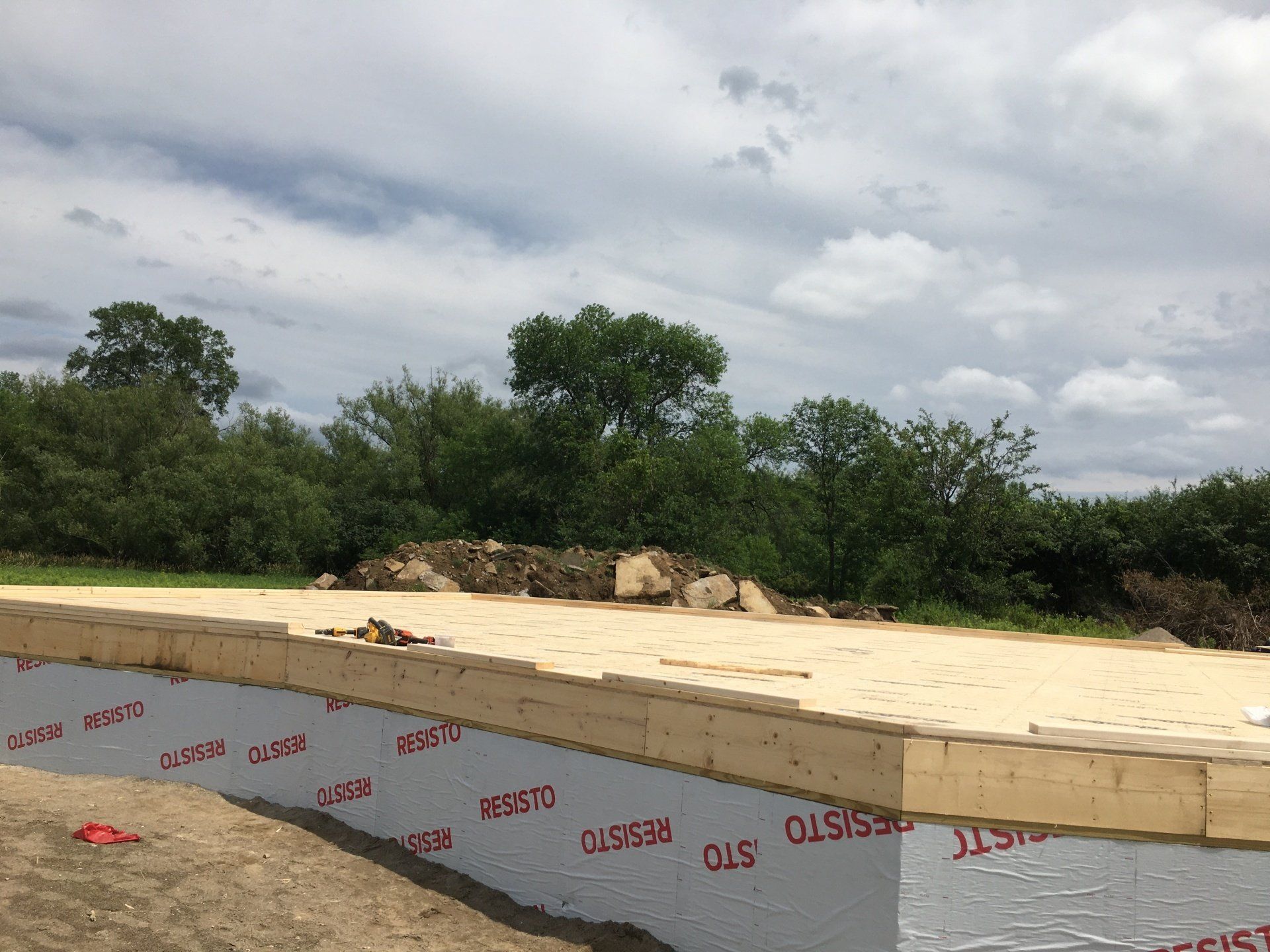 A construction site with a lot of trees in the background.