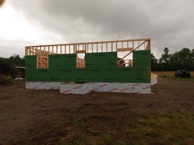 A house that is being built in a field