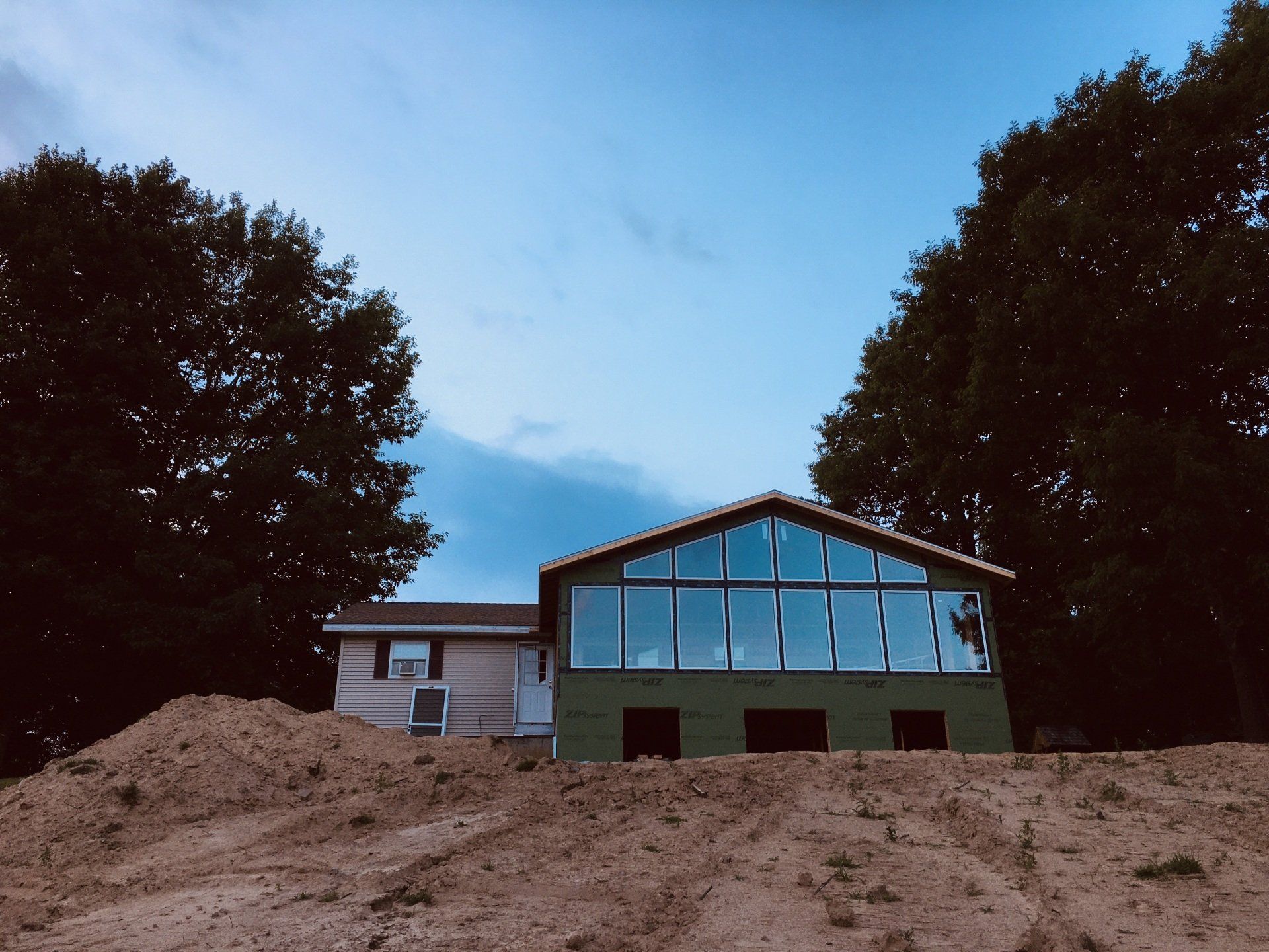 A house that is being built with a lot of windows