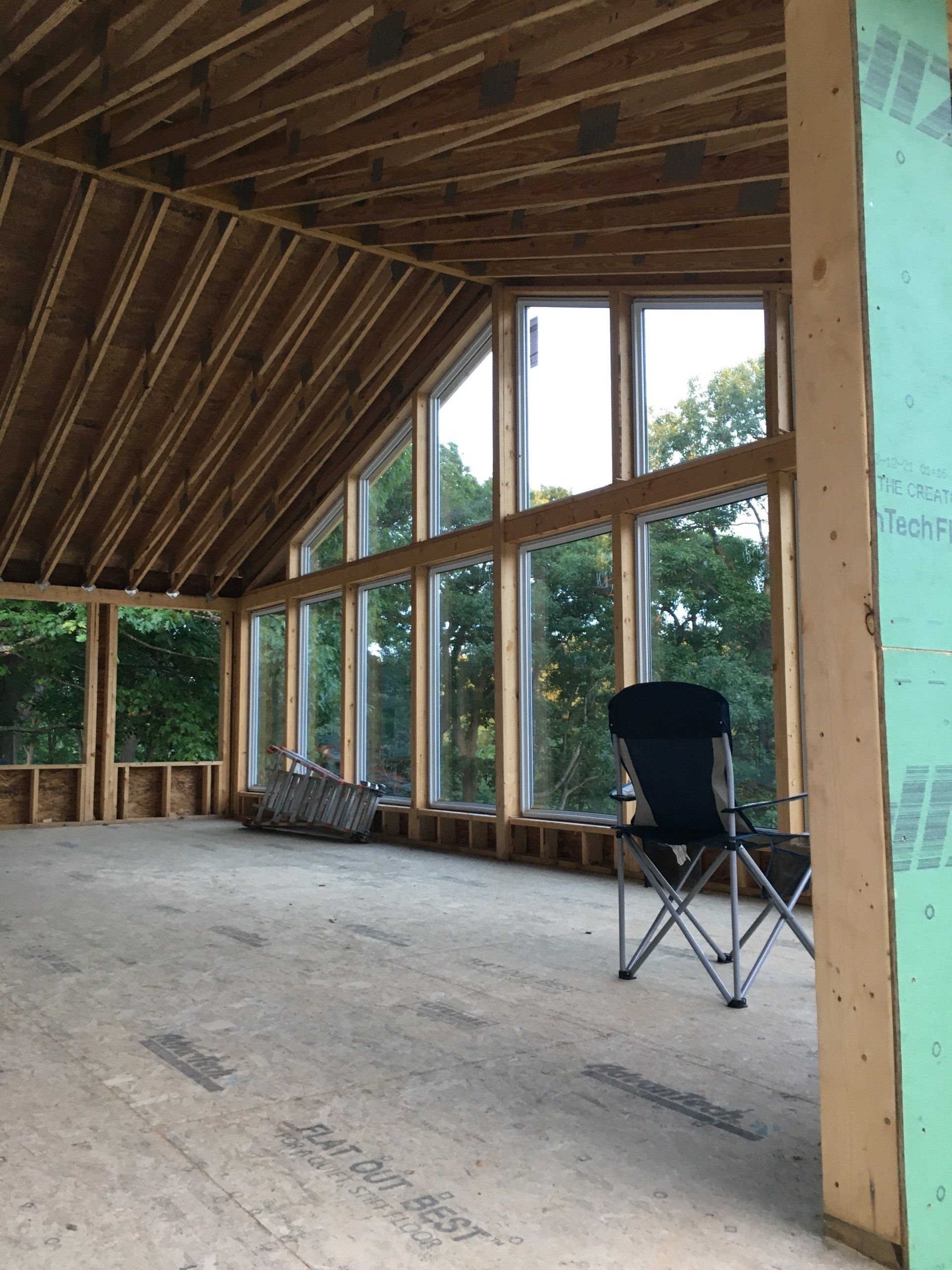 A large room with lots of windows and a chair