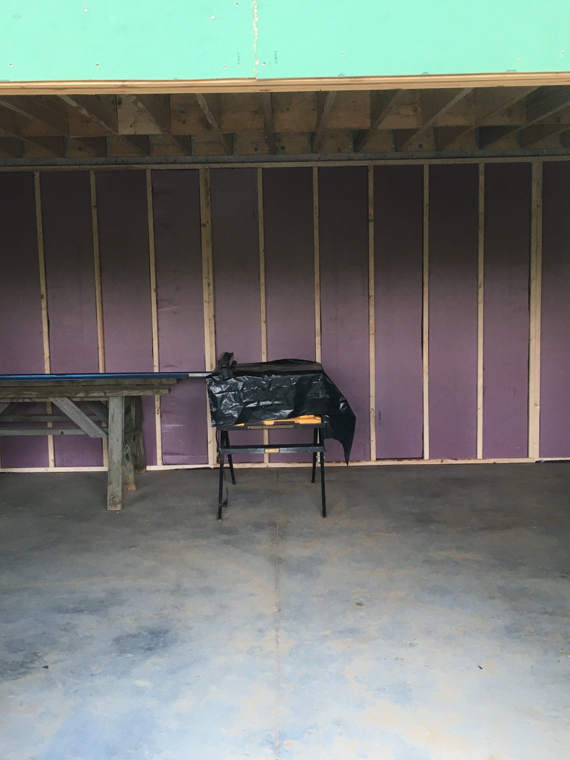 A table in a garage with purple walls