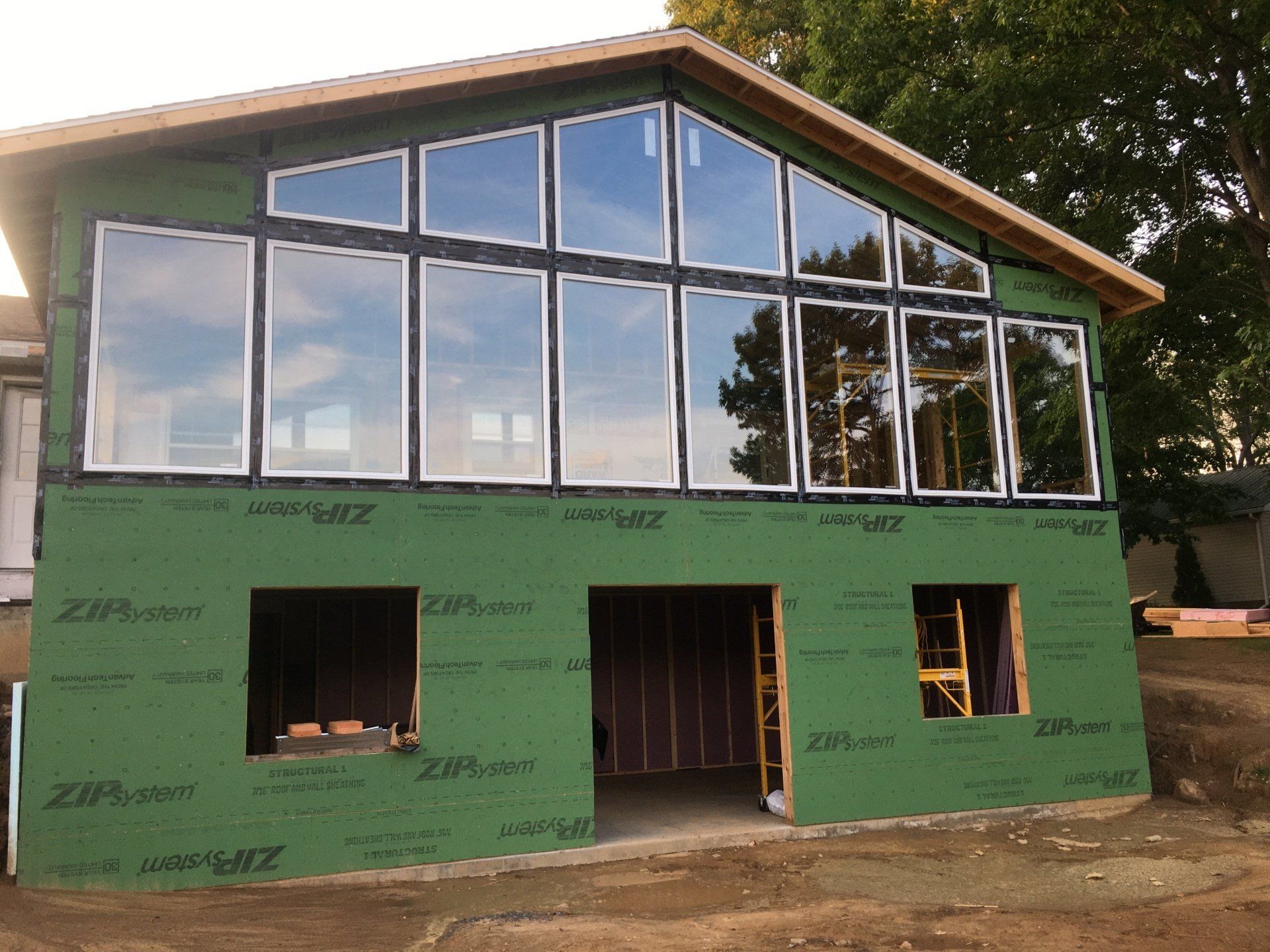 A house with a lot of windows is being built.