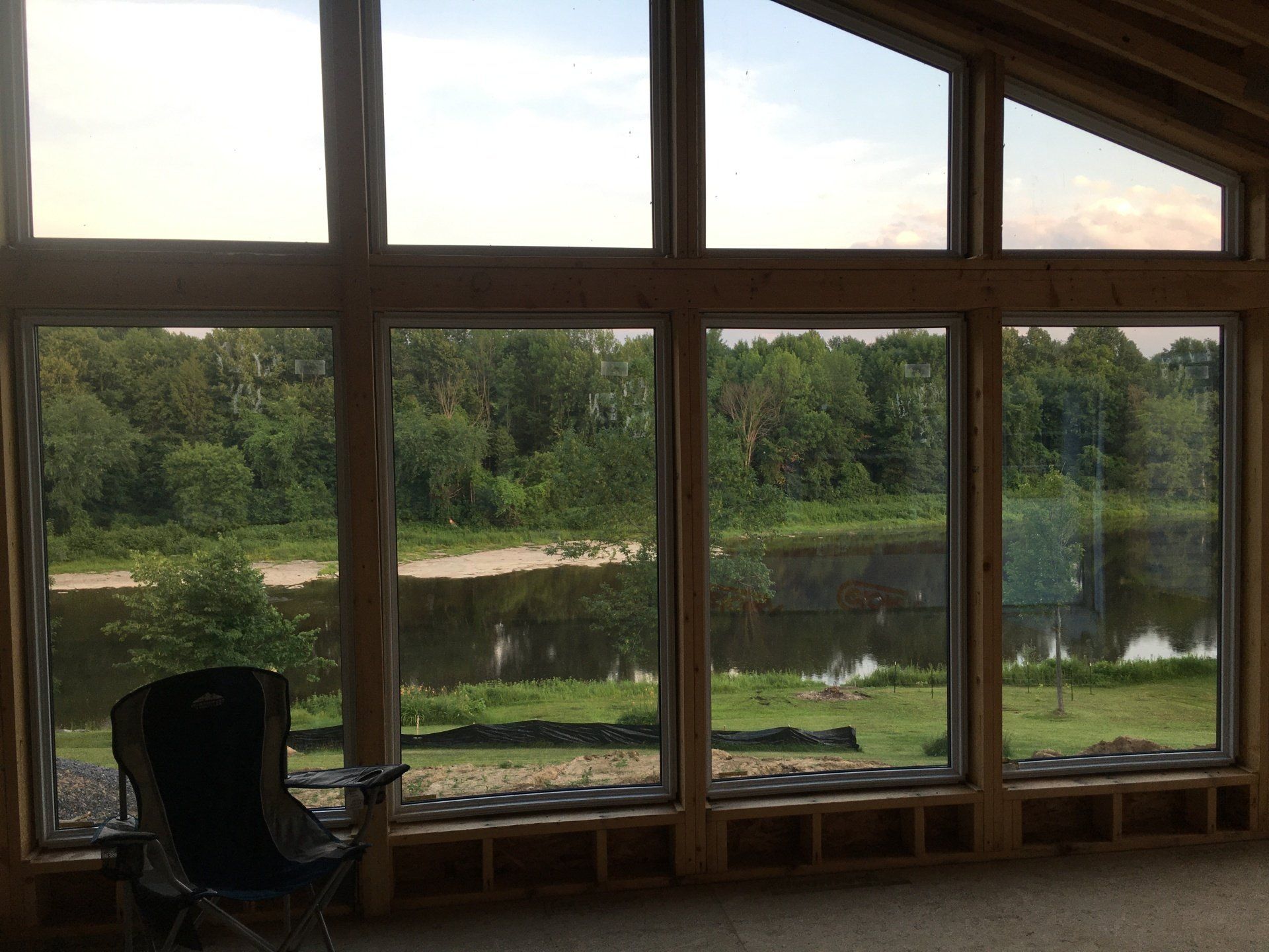 A large window with a view of a lake and trees