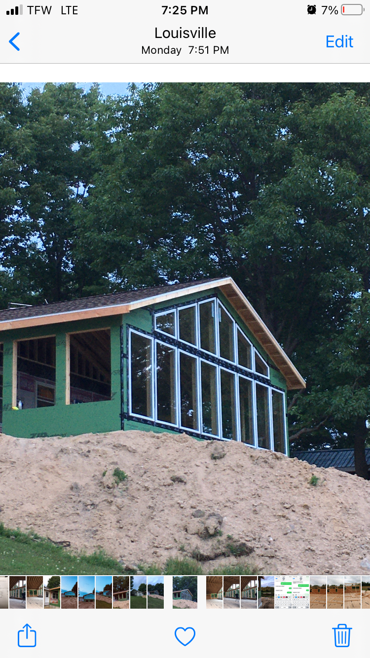 A house is being built on a hill with a lot of windows.