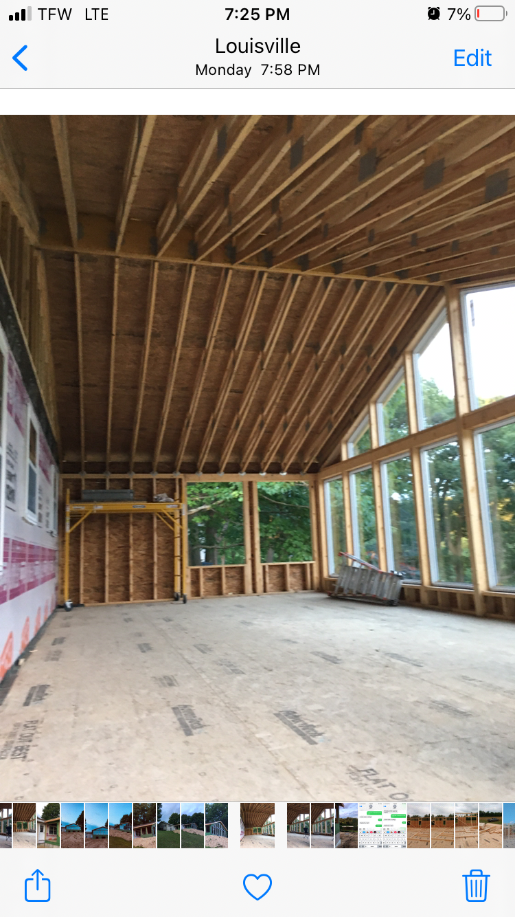 A picture of a house under construction on a cell phone.