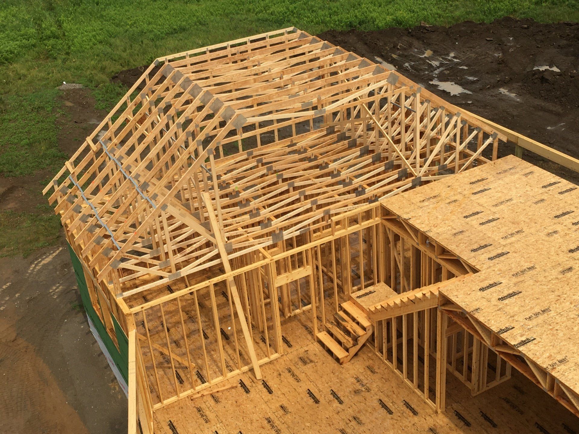 An aerial view of a wooden house under construction.