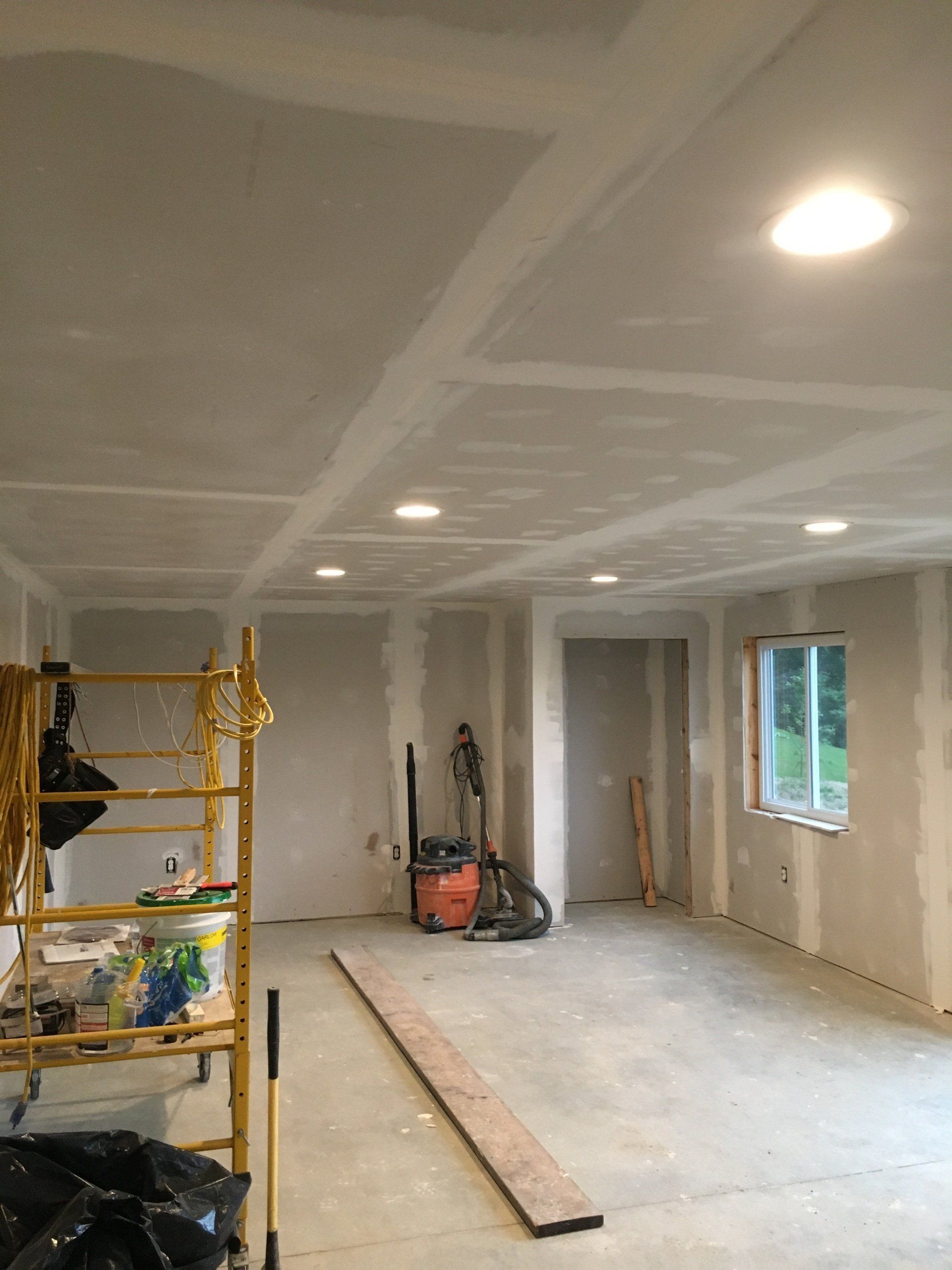 A room with a scaffolding and a vacuum cleaner in it.