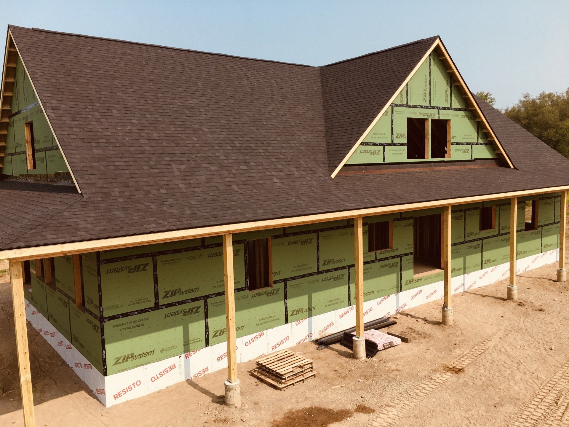 A house is being built with a porch and a roof.