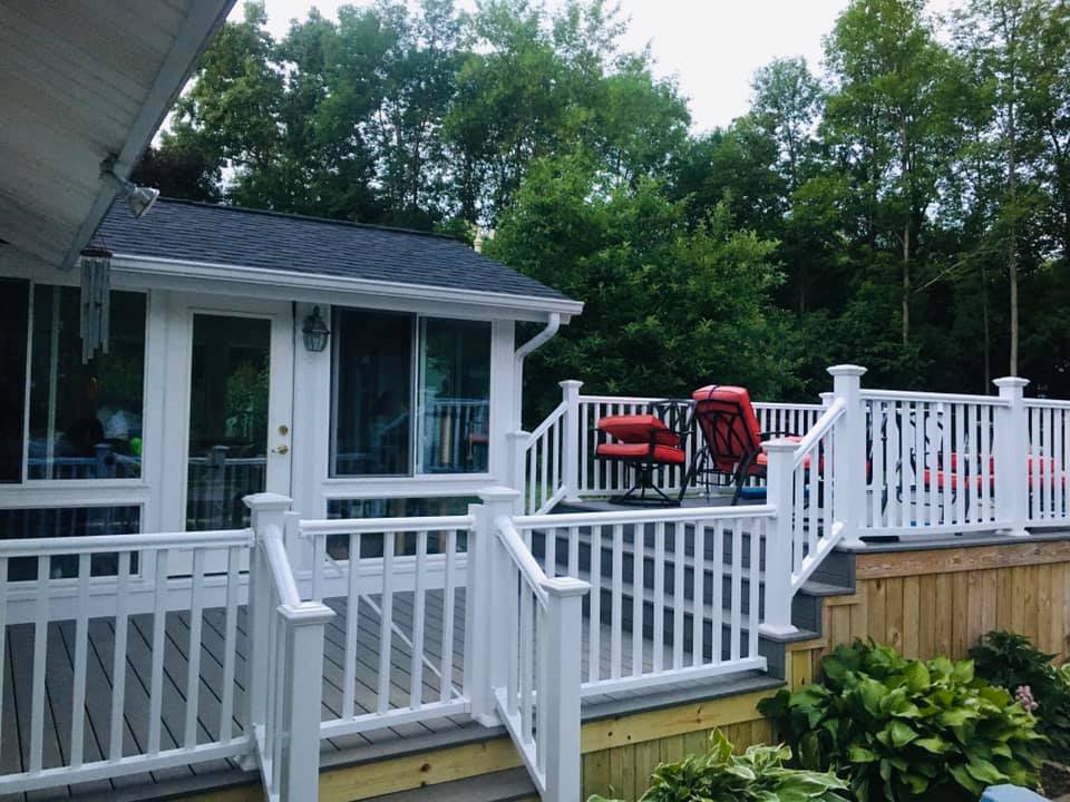 A white deck with a red chair on it