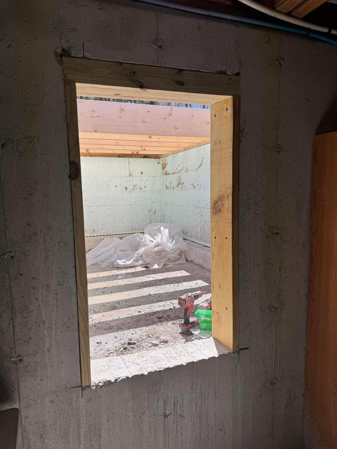 A window is being built into a wall in a room.