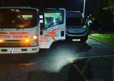 Two trucks are parked next to each other in a parking lot.